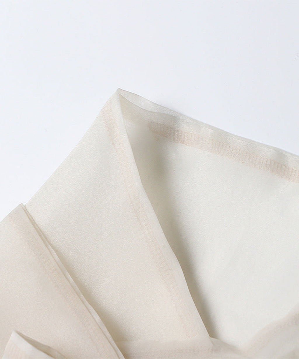 Close-up of beige fabric on a light gray background