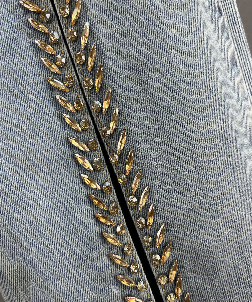 Gray fabric with gold bead embroidery on a gray background