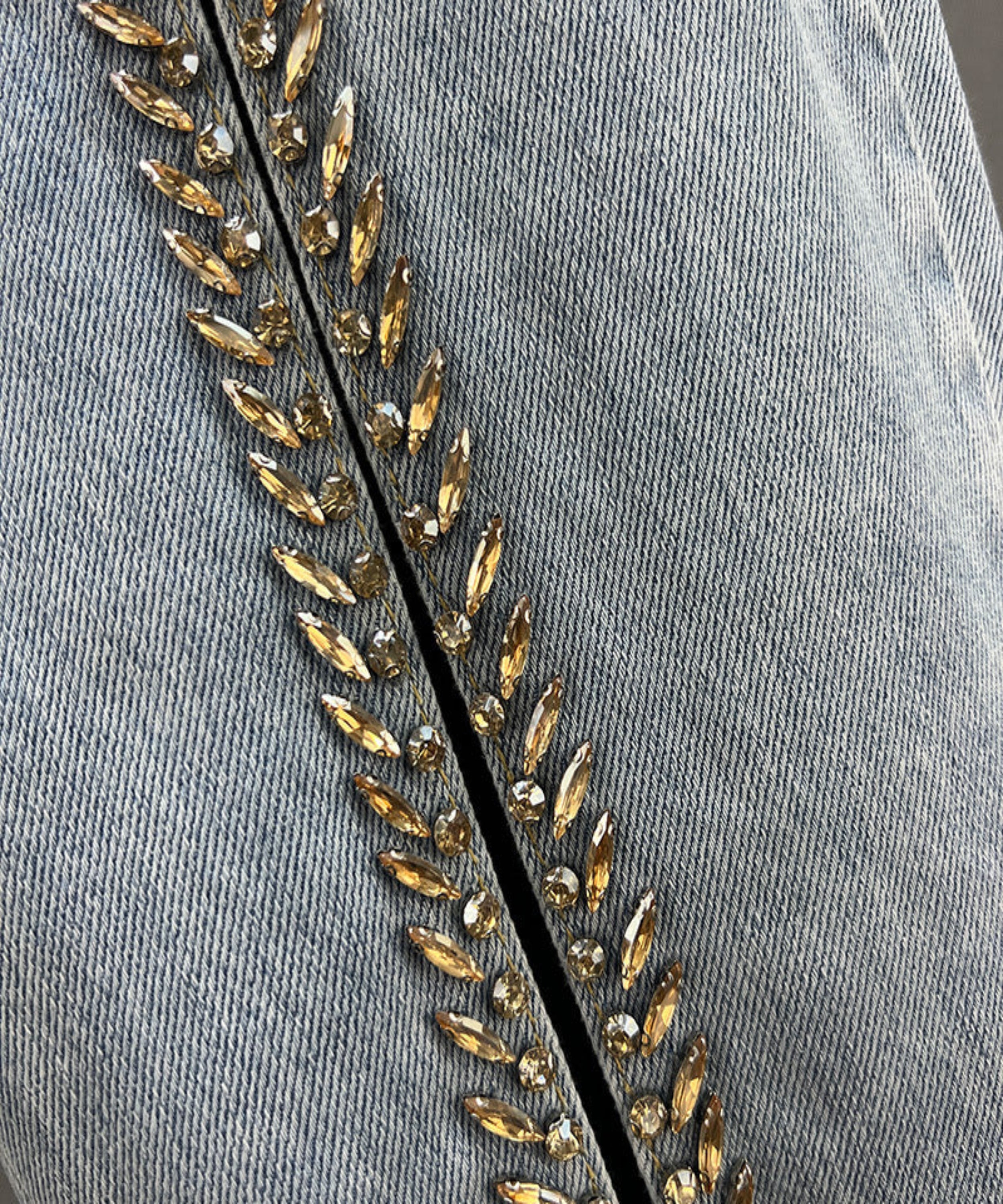 Gray fabric with gold bead embroidery on a gray background
