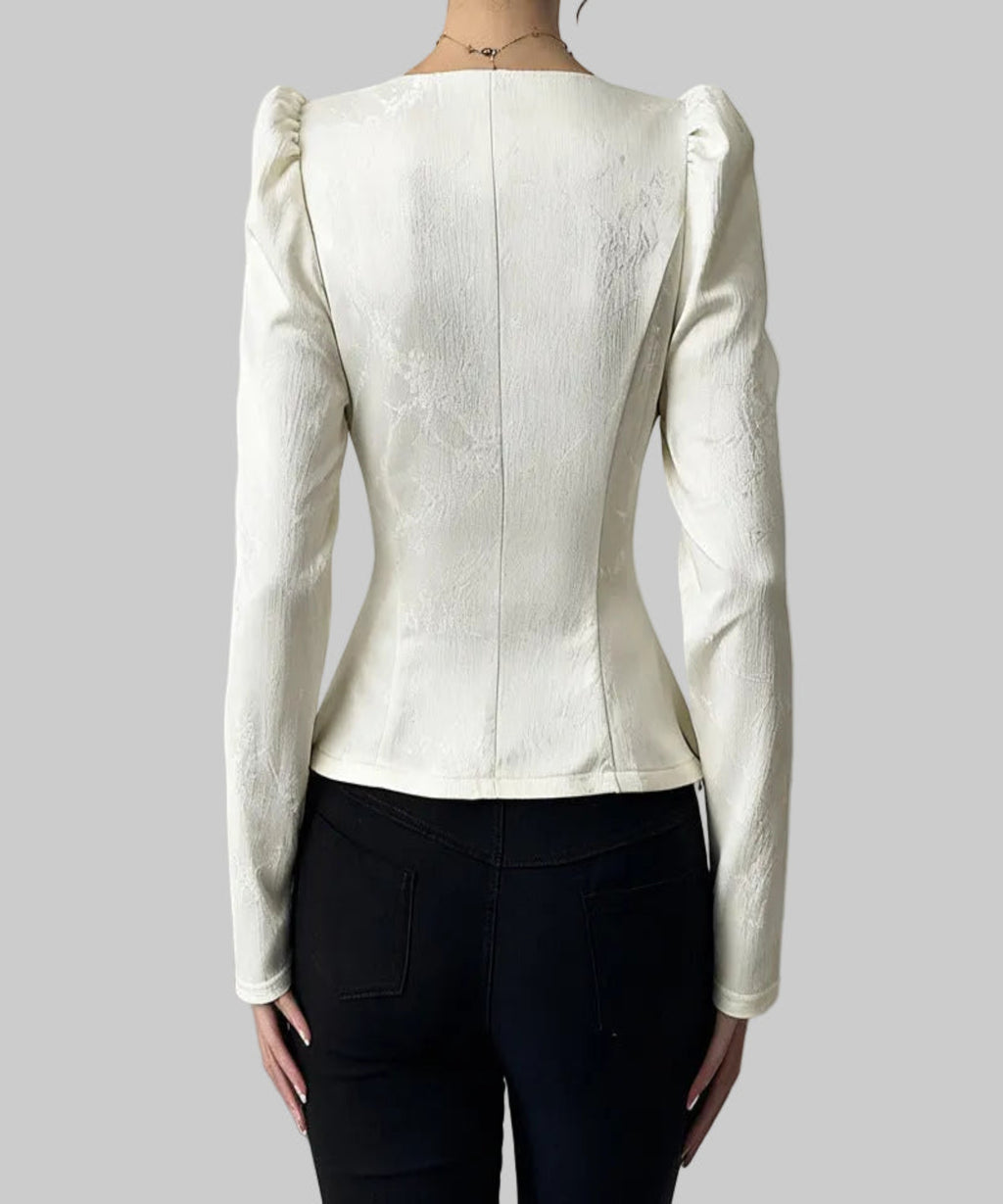 White textured blazer worn by a person on a plain background