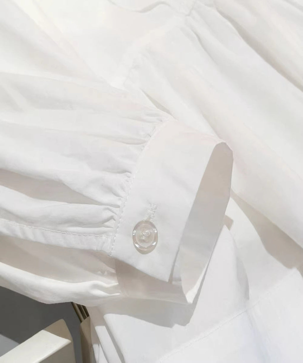 Close-up of a white shirt with a button and cuff