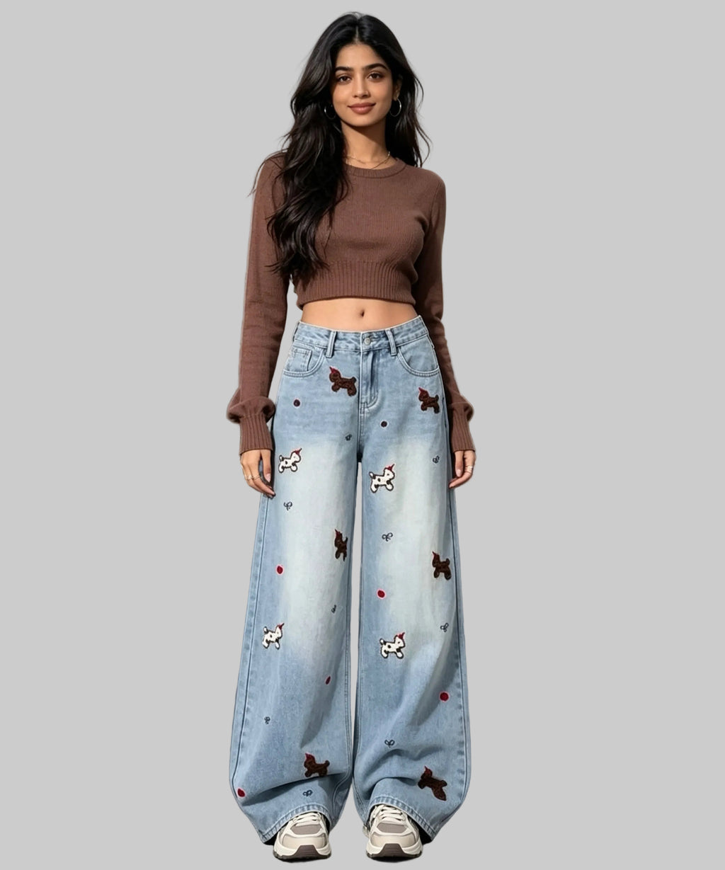 Woman in brown top and light blue jeans with animal prints on  a white background.
