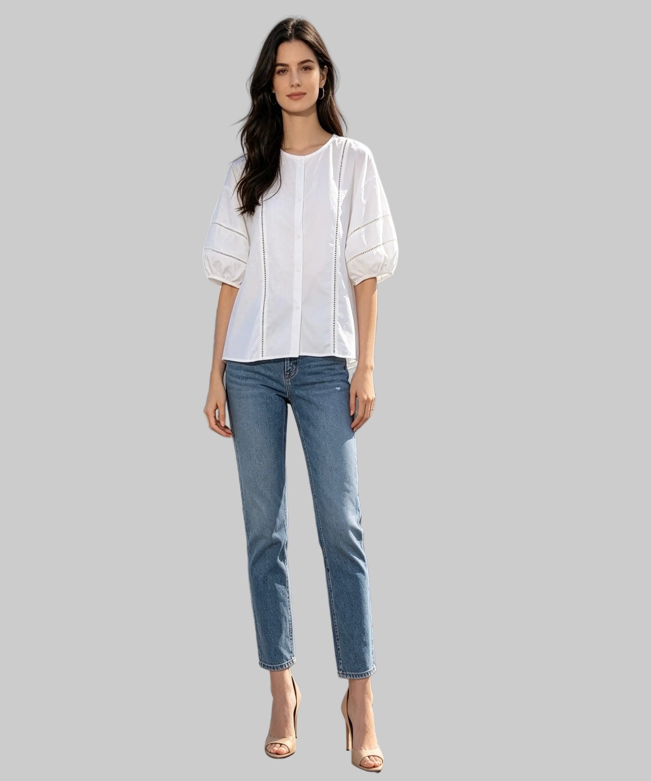 Woman in white blouse and blue jeans standing on a white background