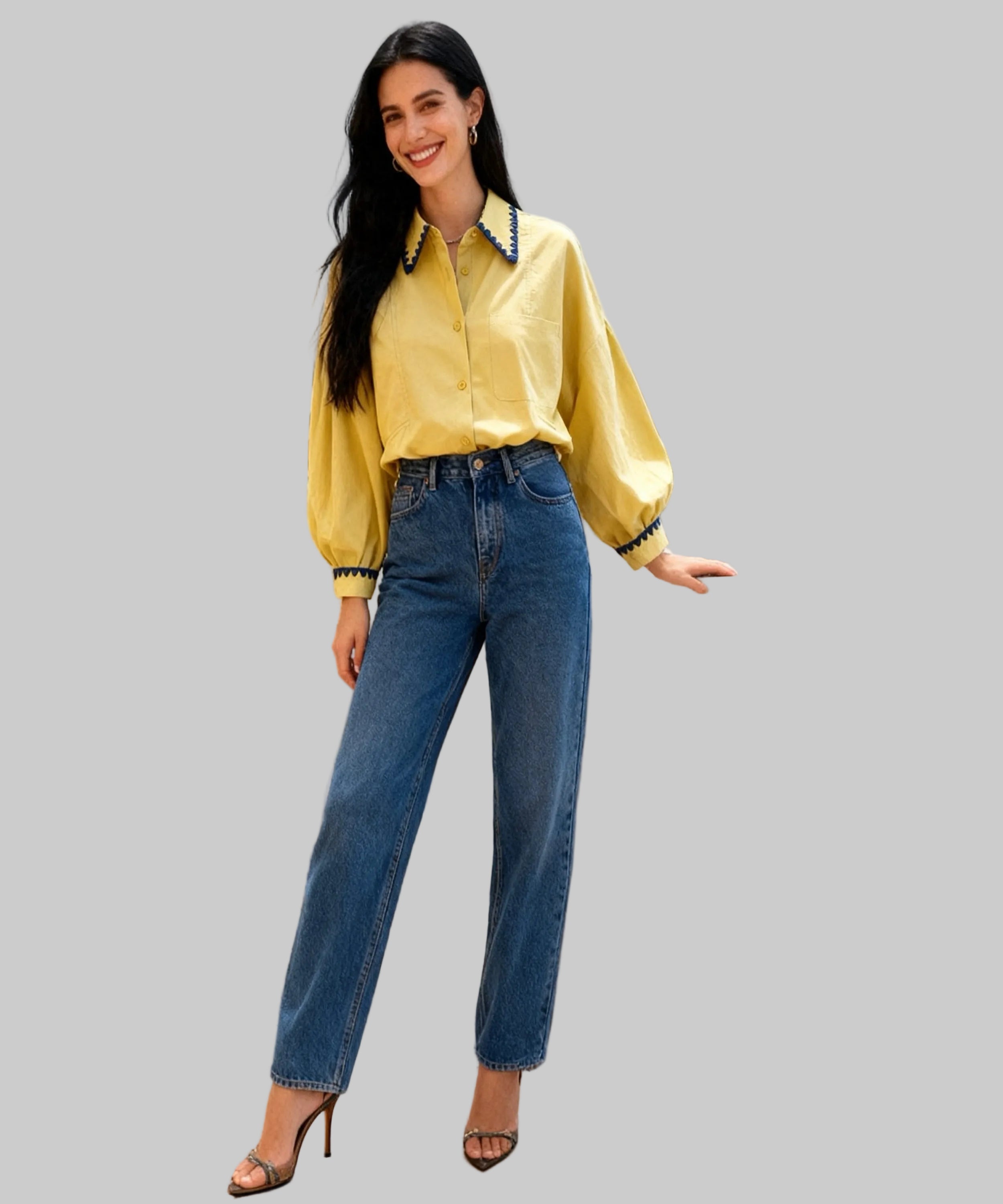 Woman in a yellow blouse and blue jeans standing on a white background
