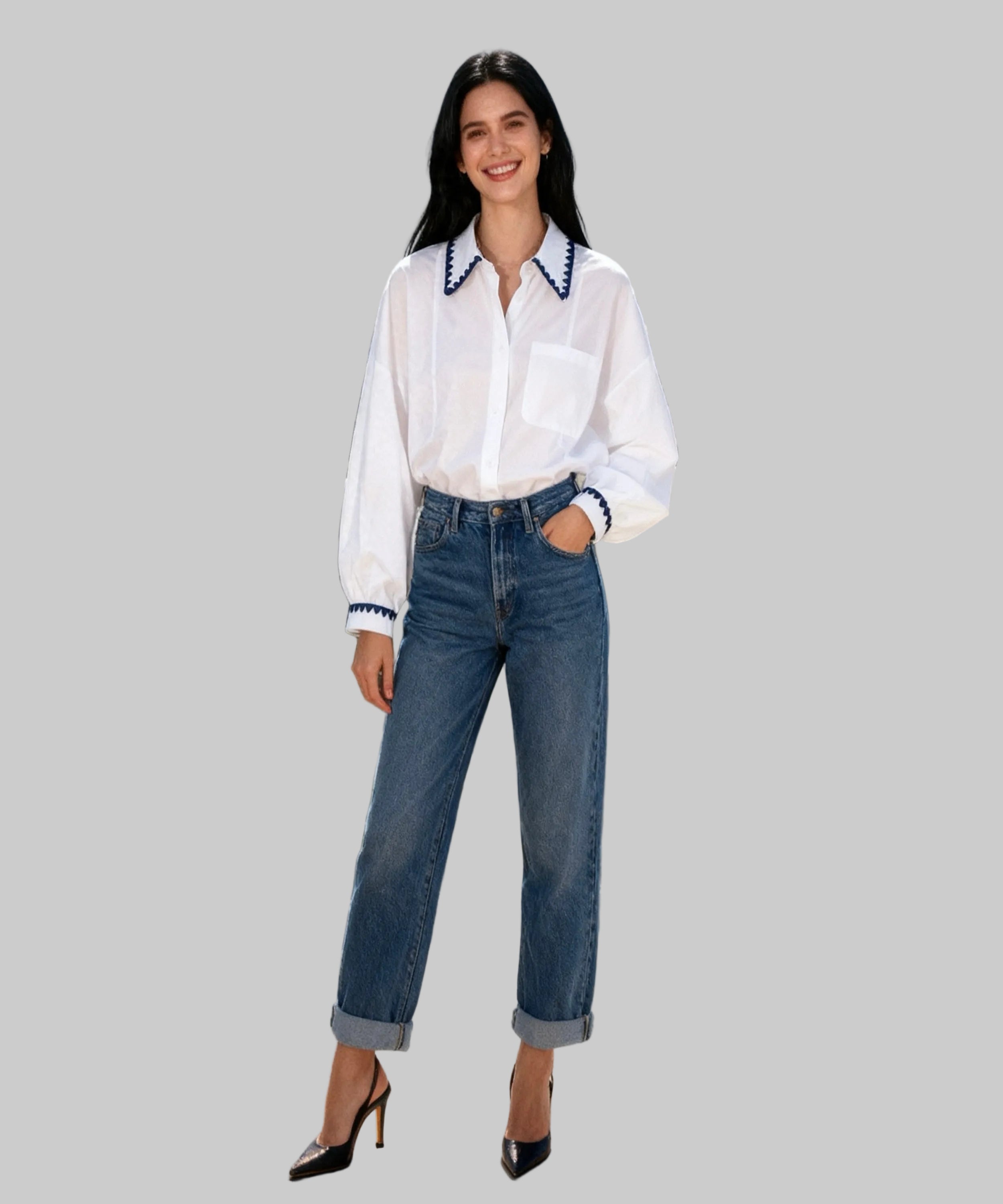 Woman in white blouse and blue jeans standing  in white background