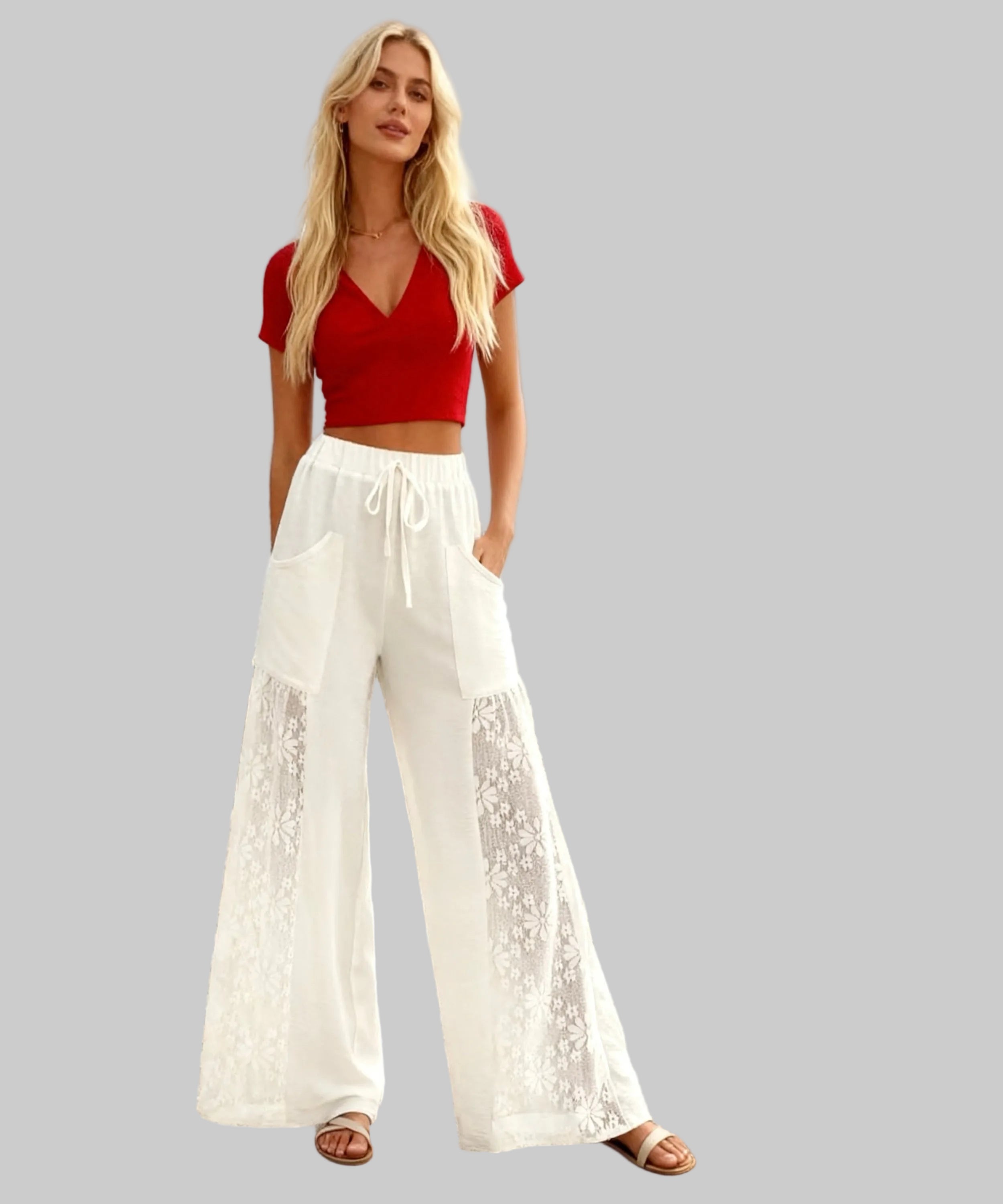 Woman in red top and white pants standing on a white background