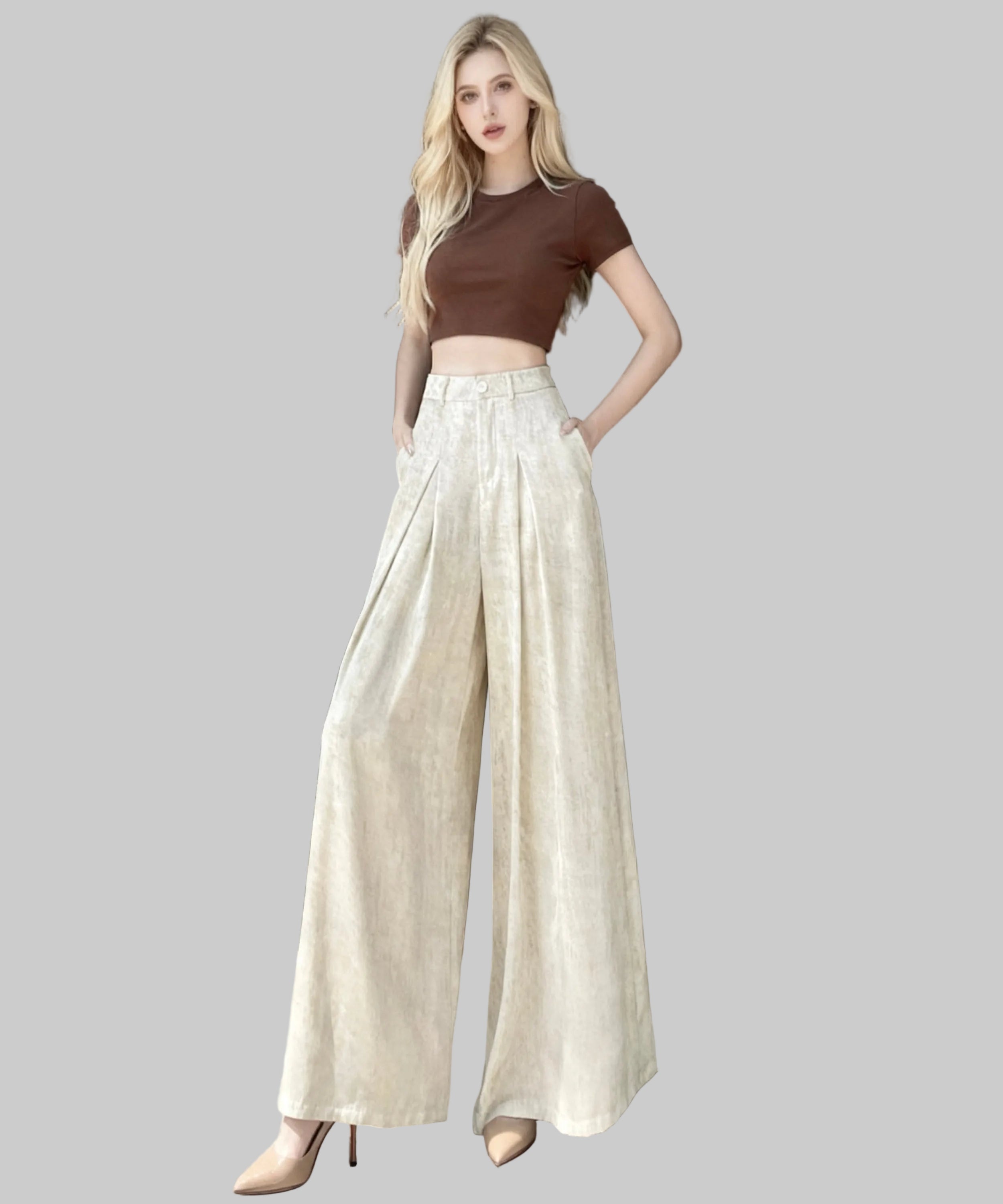 women wearing brown top and white trousers sitting on a white background