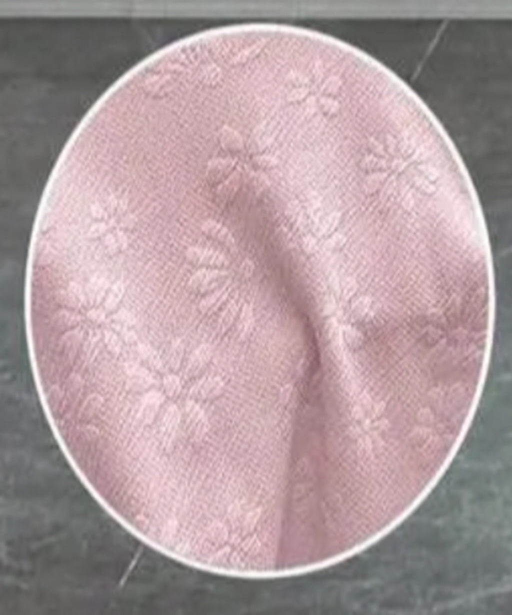 Close-up of pink fabric texture on a dark background