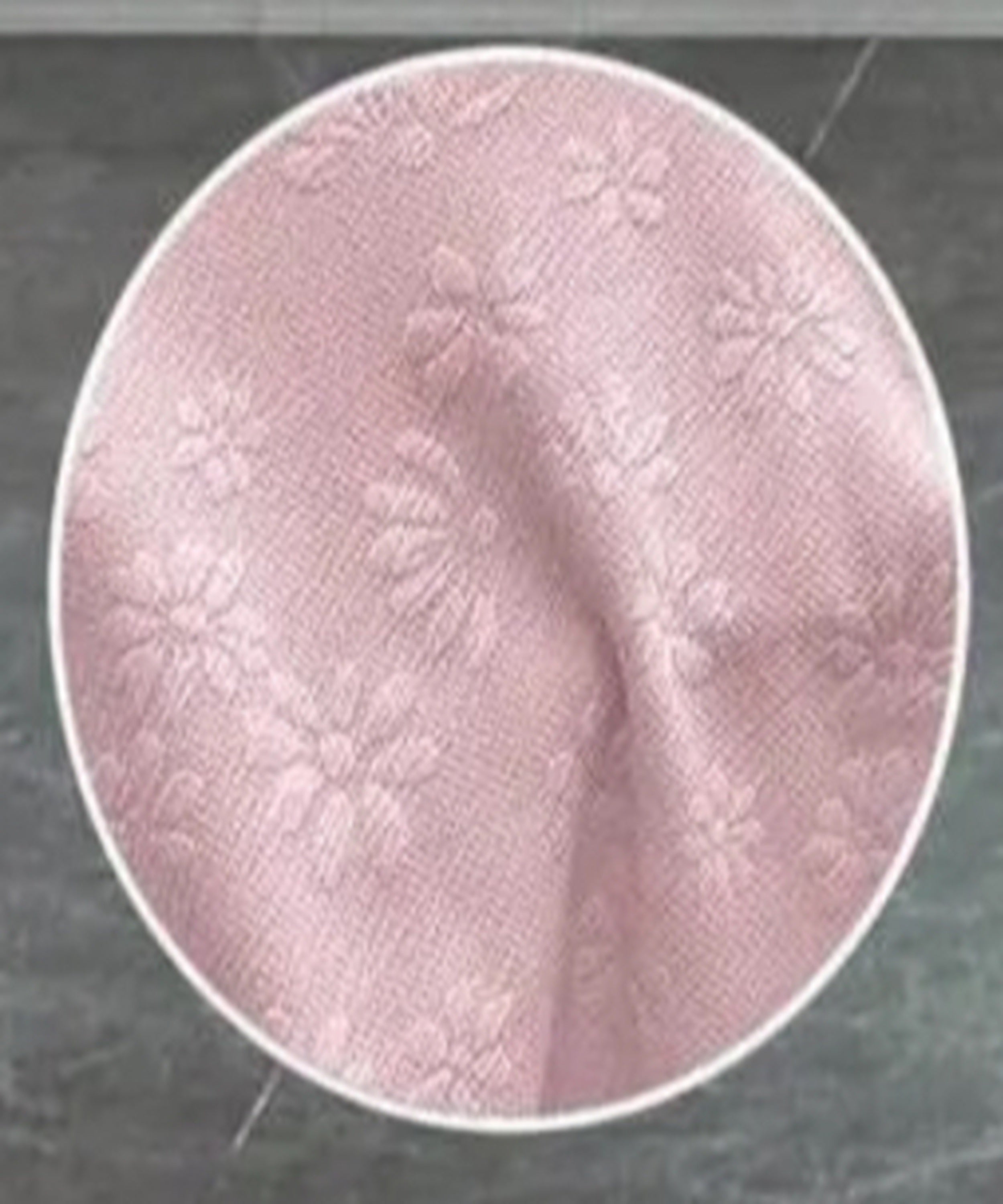 Close-up of pink fabric texture on a dark background
