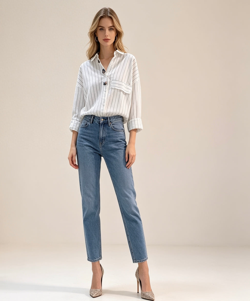 Woman wearing a white striped shirt and blue jeans on a beige background