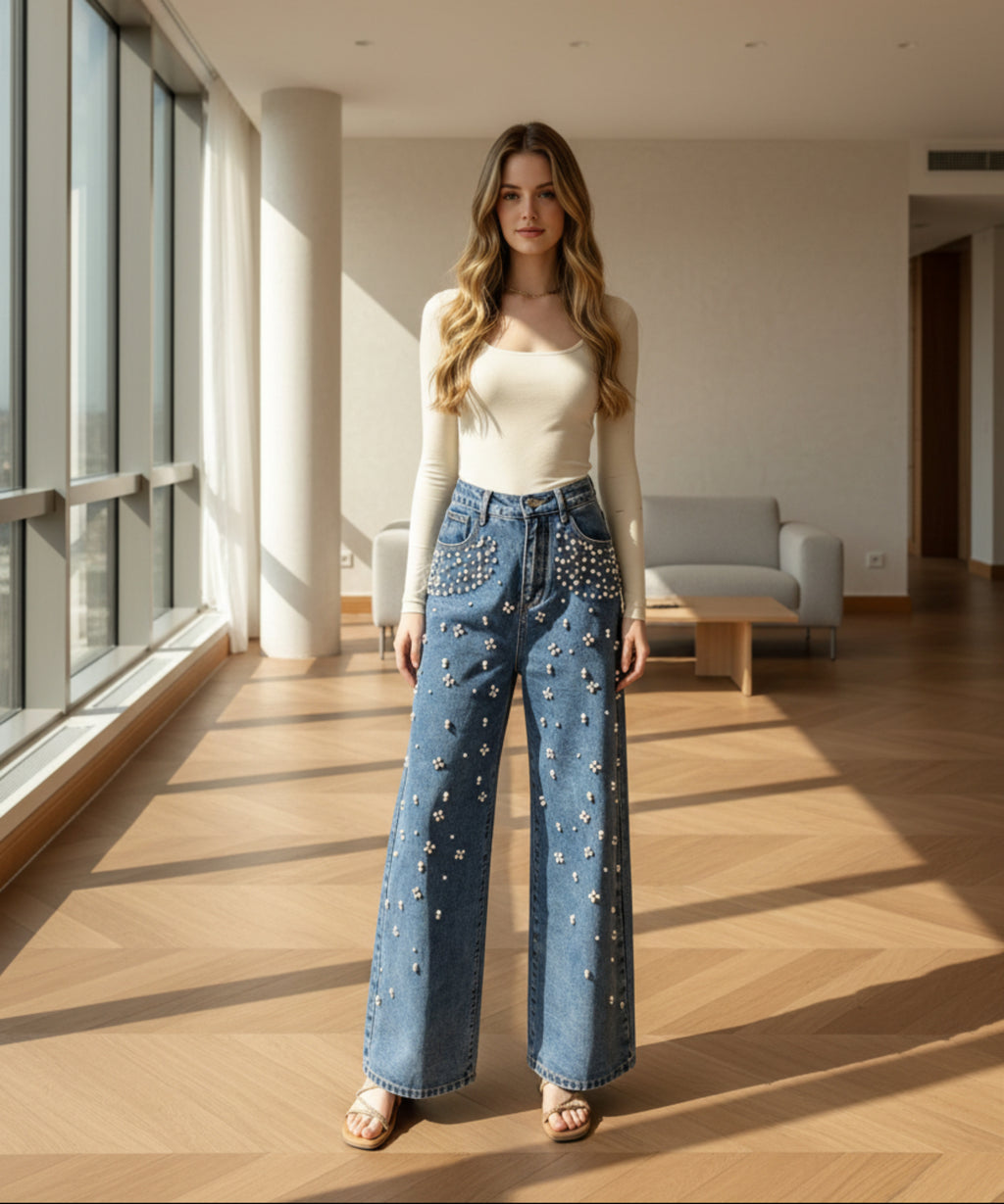 Woman wearing blue jeans with star patterns in a living room.
