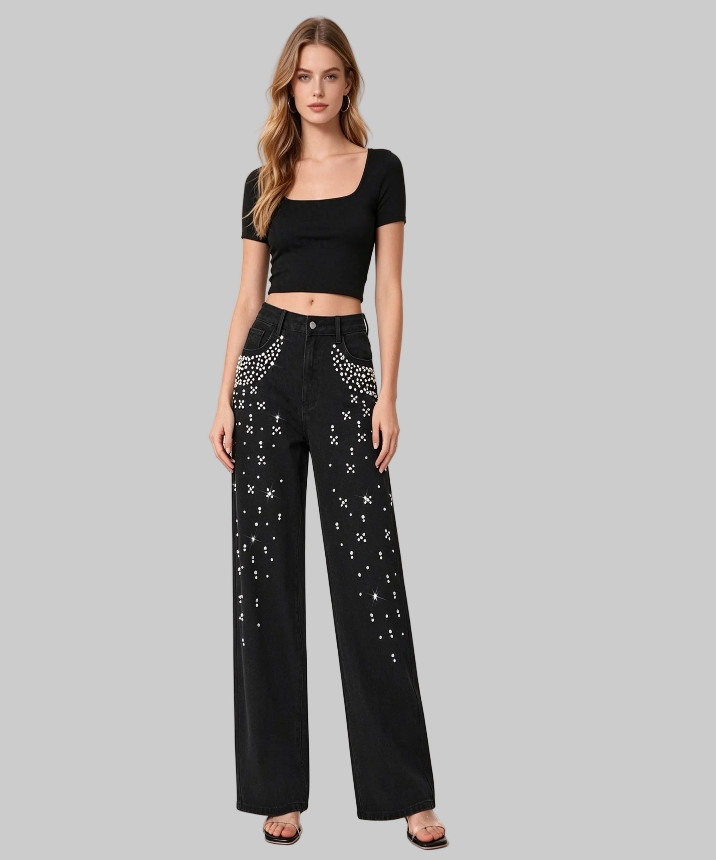 Woman wearing black top and pants with star patterns on a white background