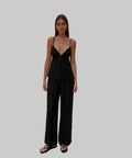 Woman in a black outfit standing on a white  background