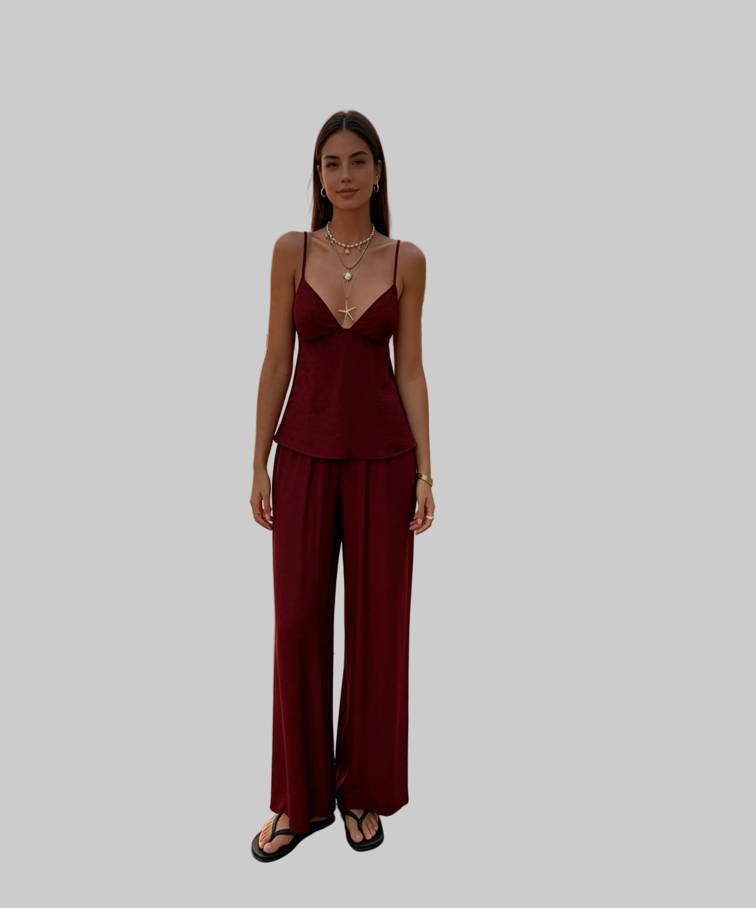 Woman in a red outfit standing on a white background