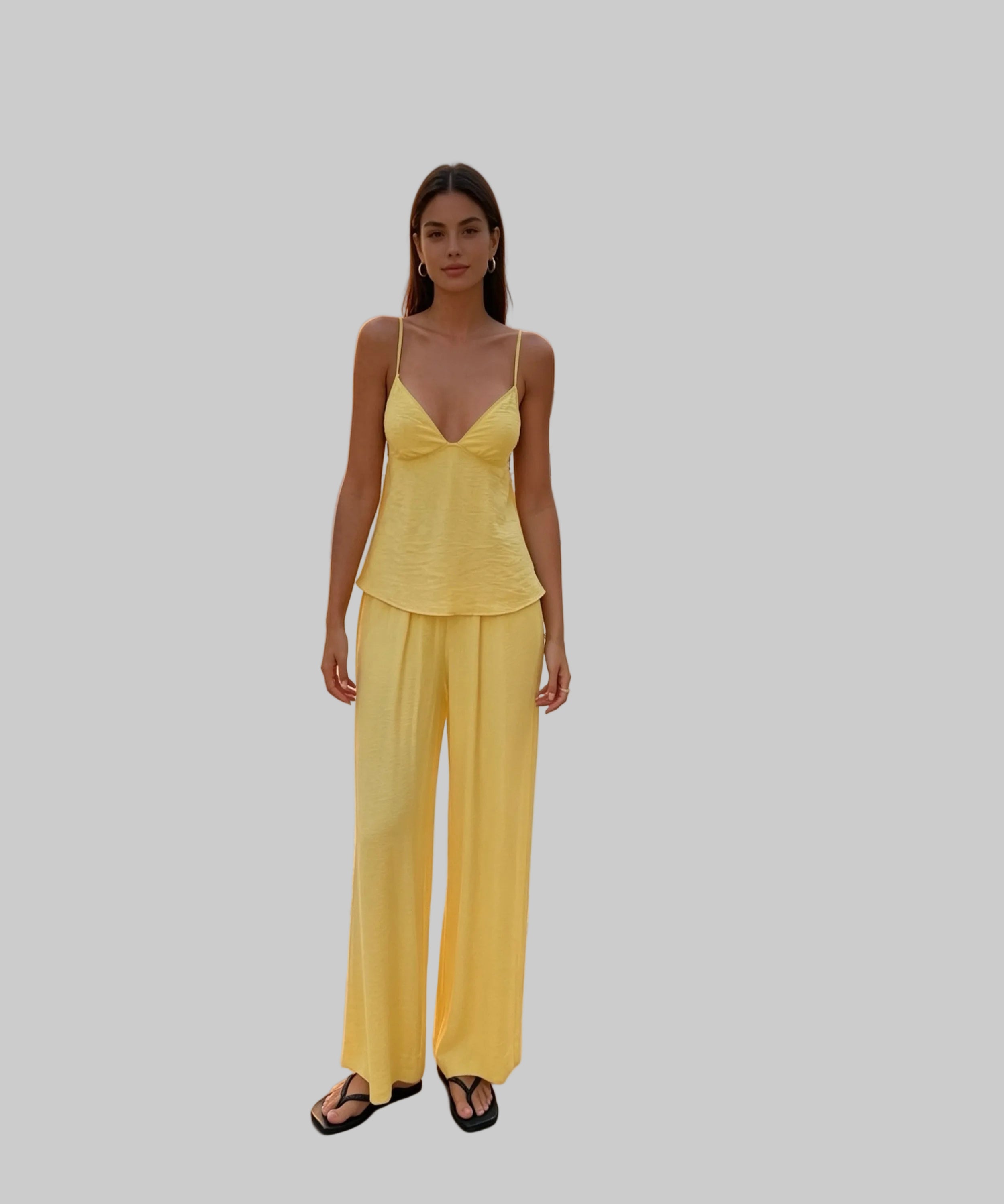 Woman in a yellow outfit standing on a white background