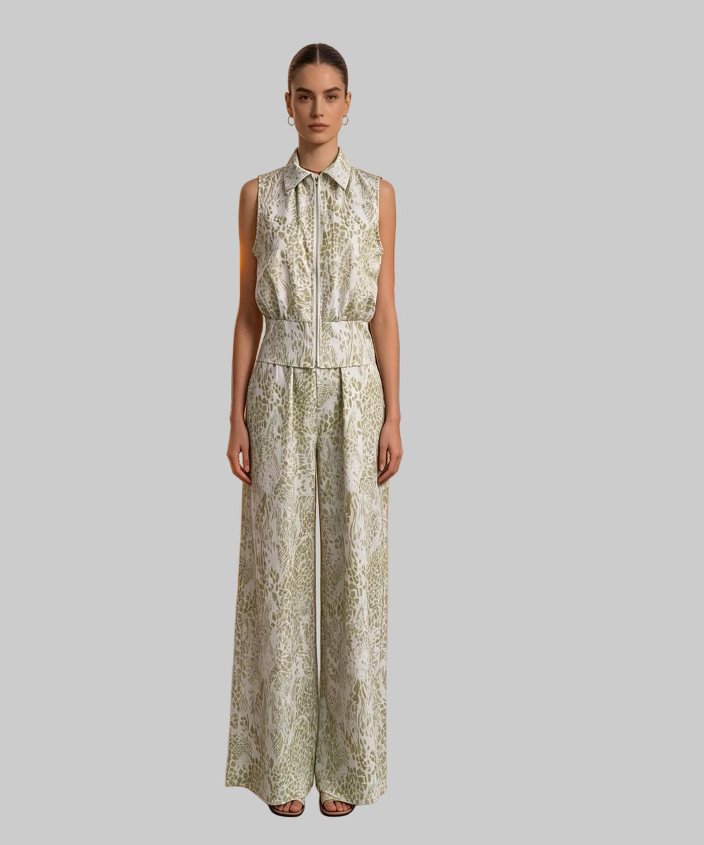 Woman in a patterned dress standing on a white background