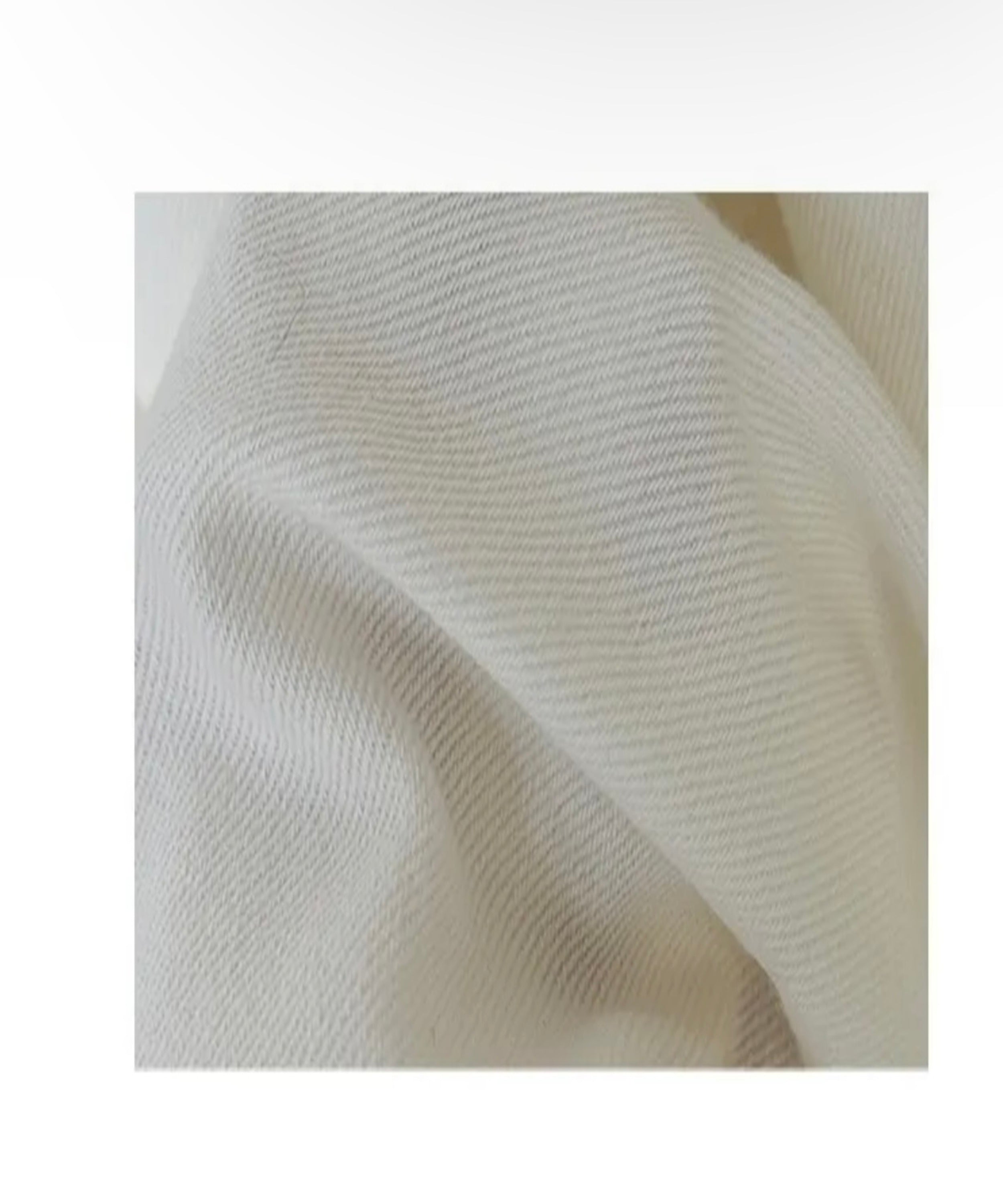 Close-up of textured white fabric on a light background