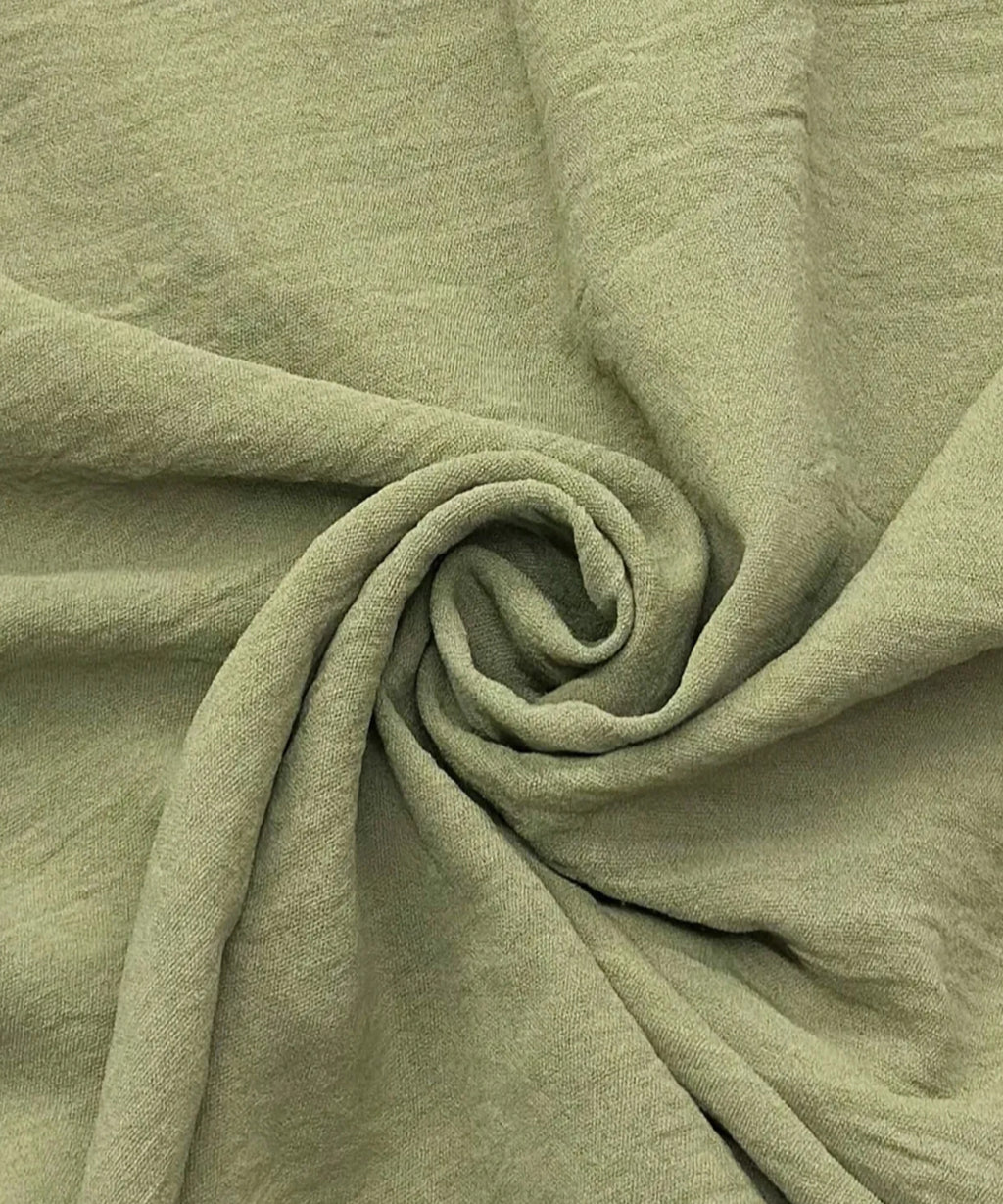 Close-up of green fabric with folds