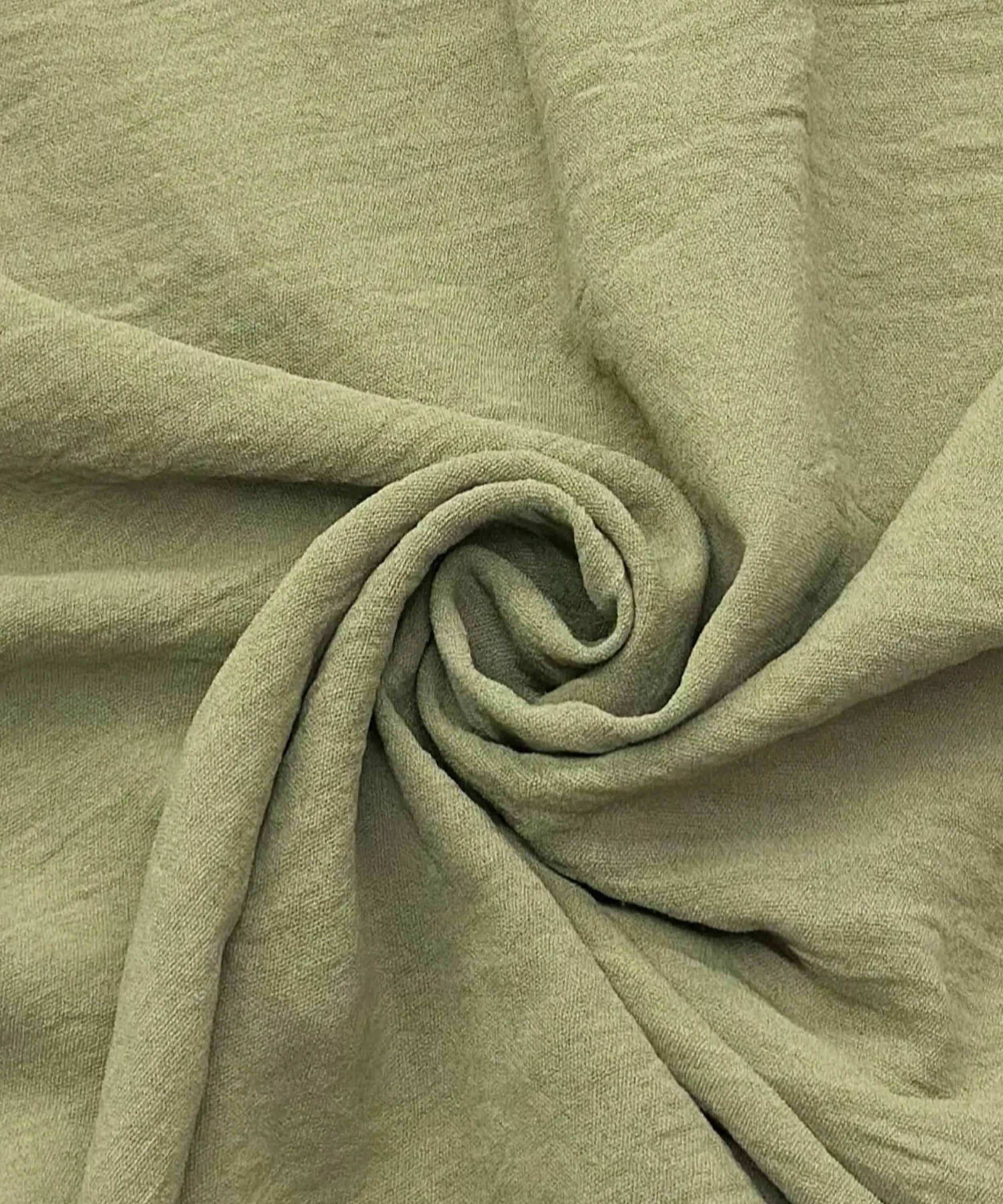 Close-up of green fabric with folds