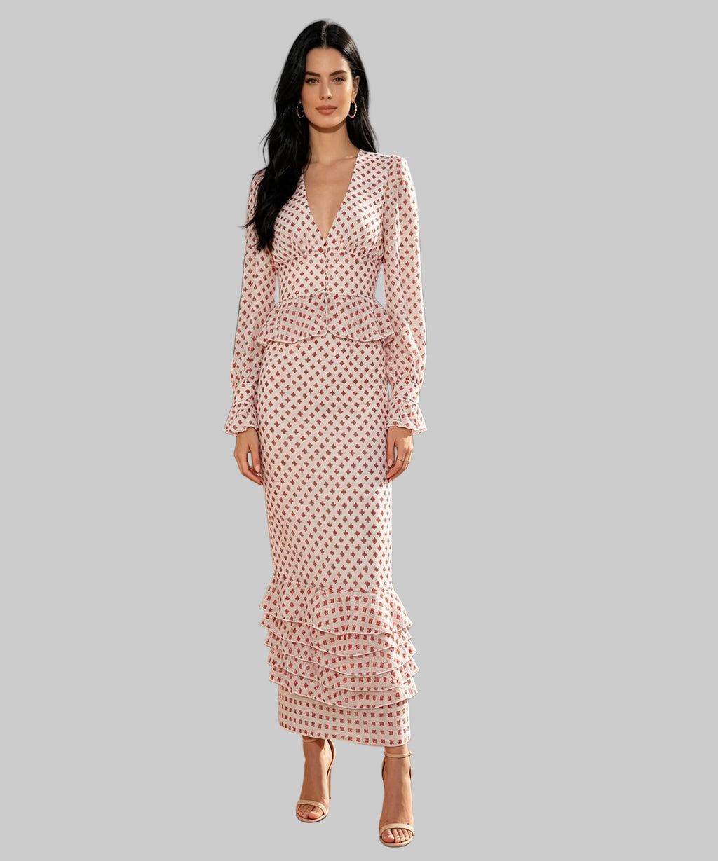 Woman in a patterned dress standing on a white background