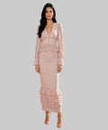 Woman in a patterned dress standing on a white background