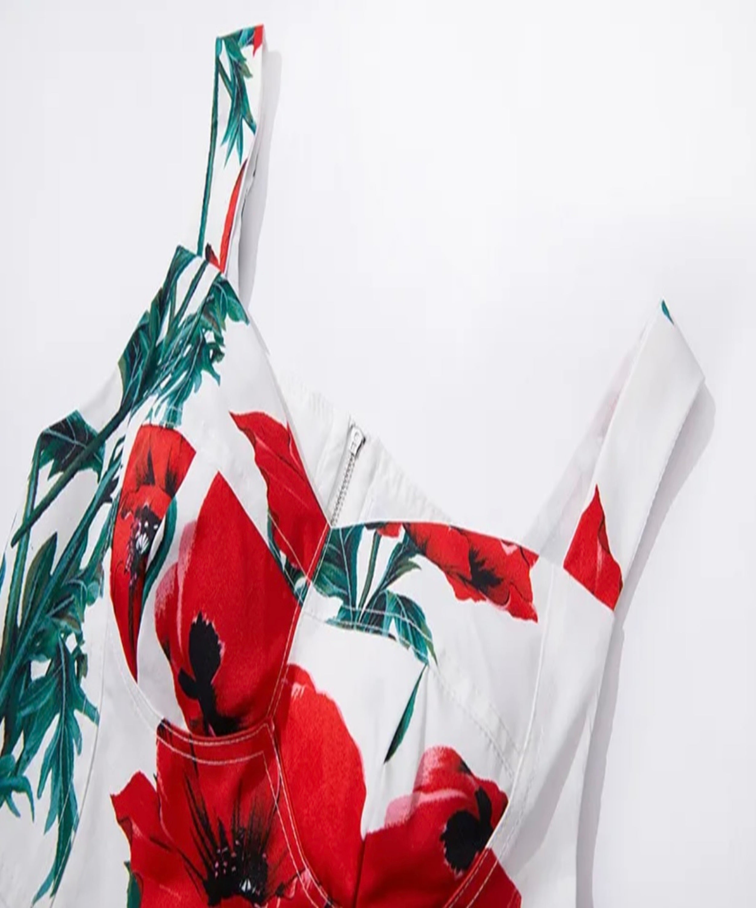 White top with red floral pattern on a white background