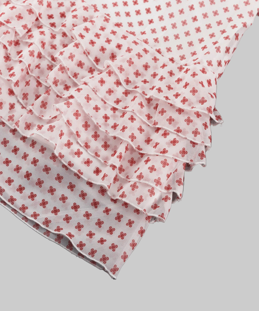 White fabric with red floral patterns on a white background