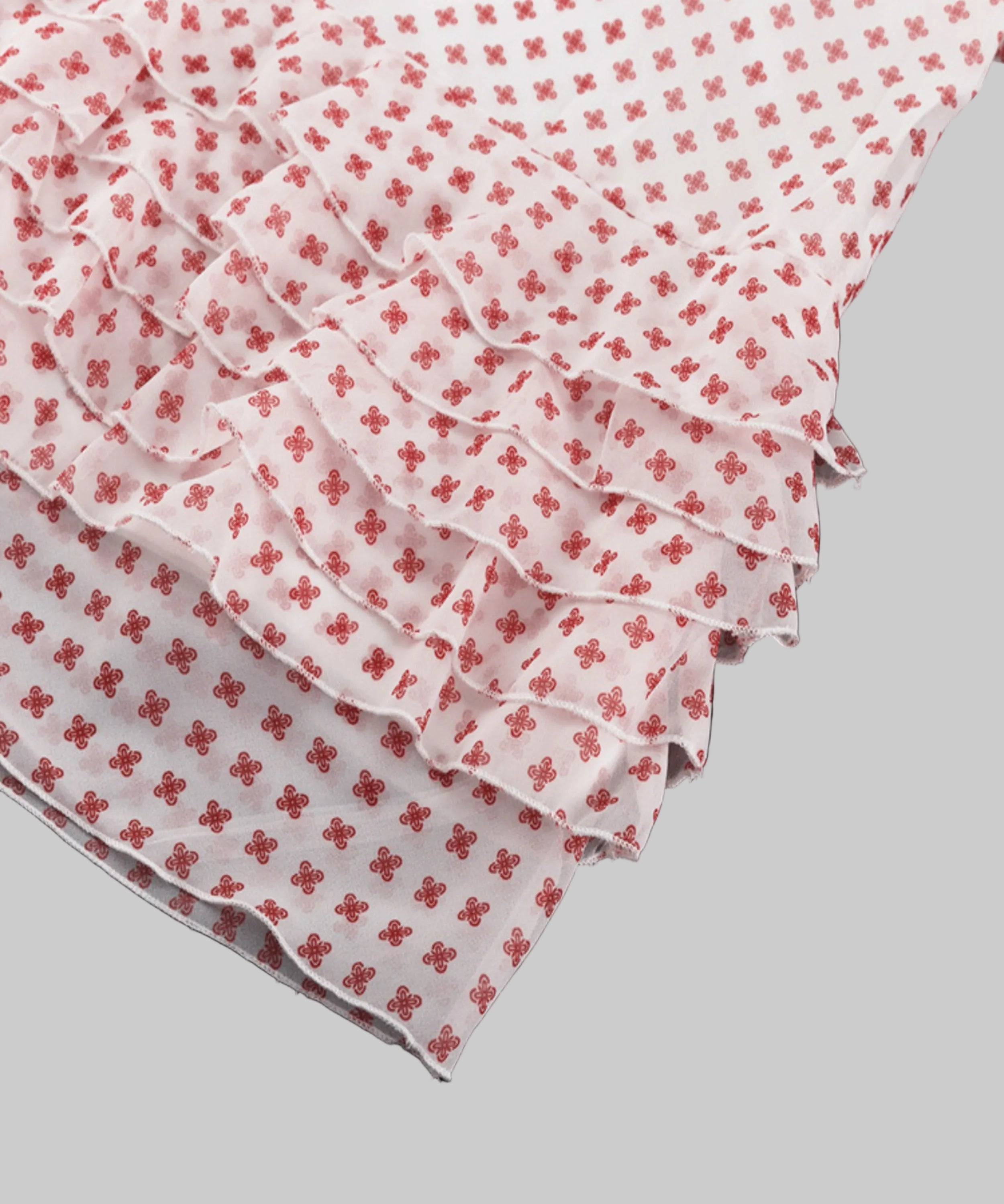 White fabric with red floral patterns on a white background