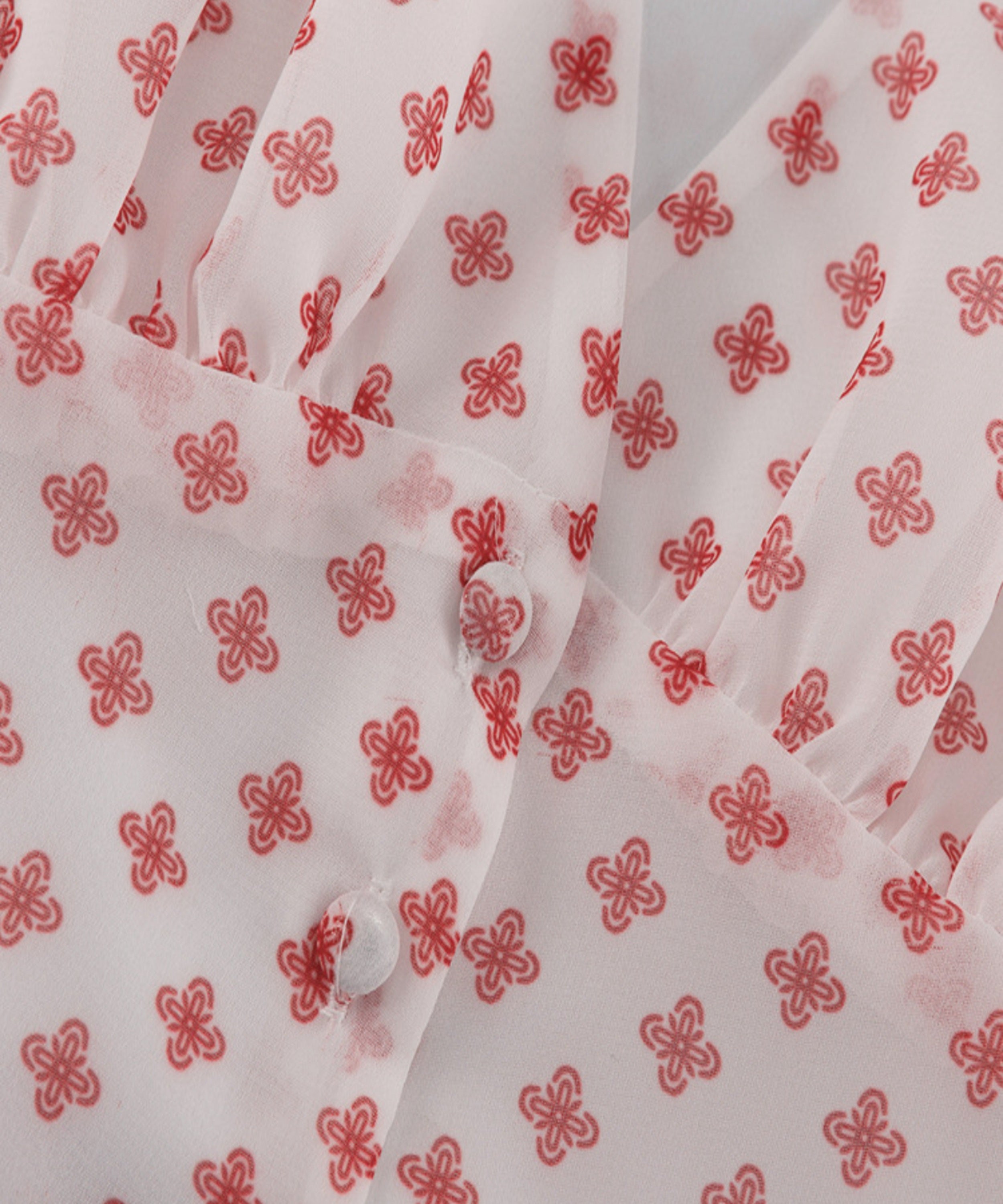 White shirt with red floral patterns on a white background