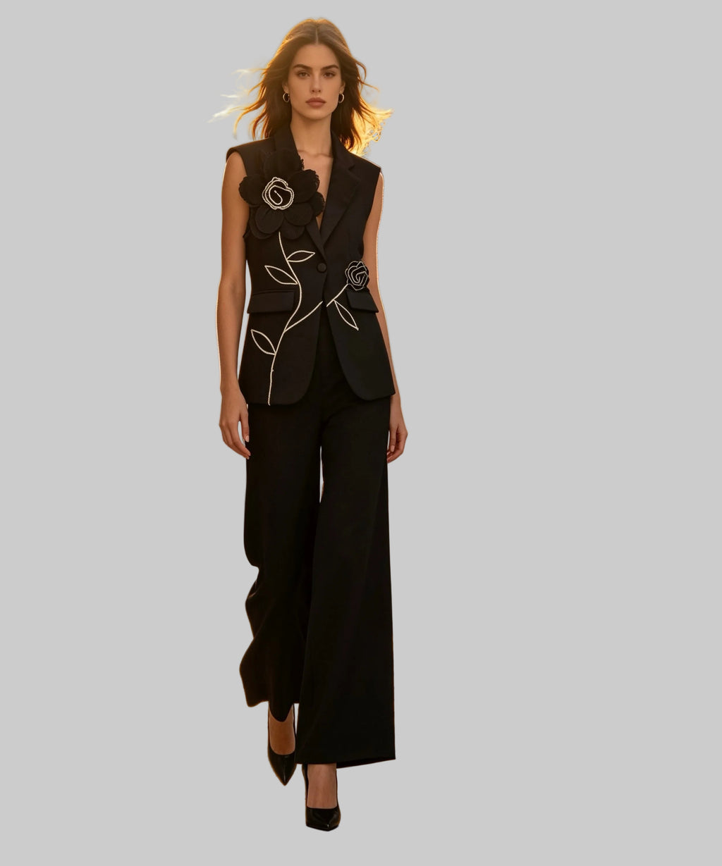 Woman in a black outfit standing on a white background