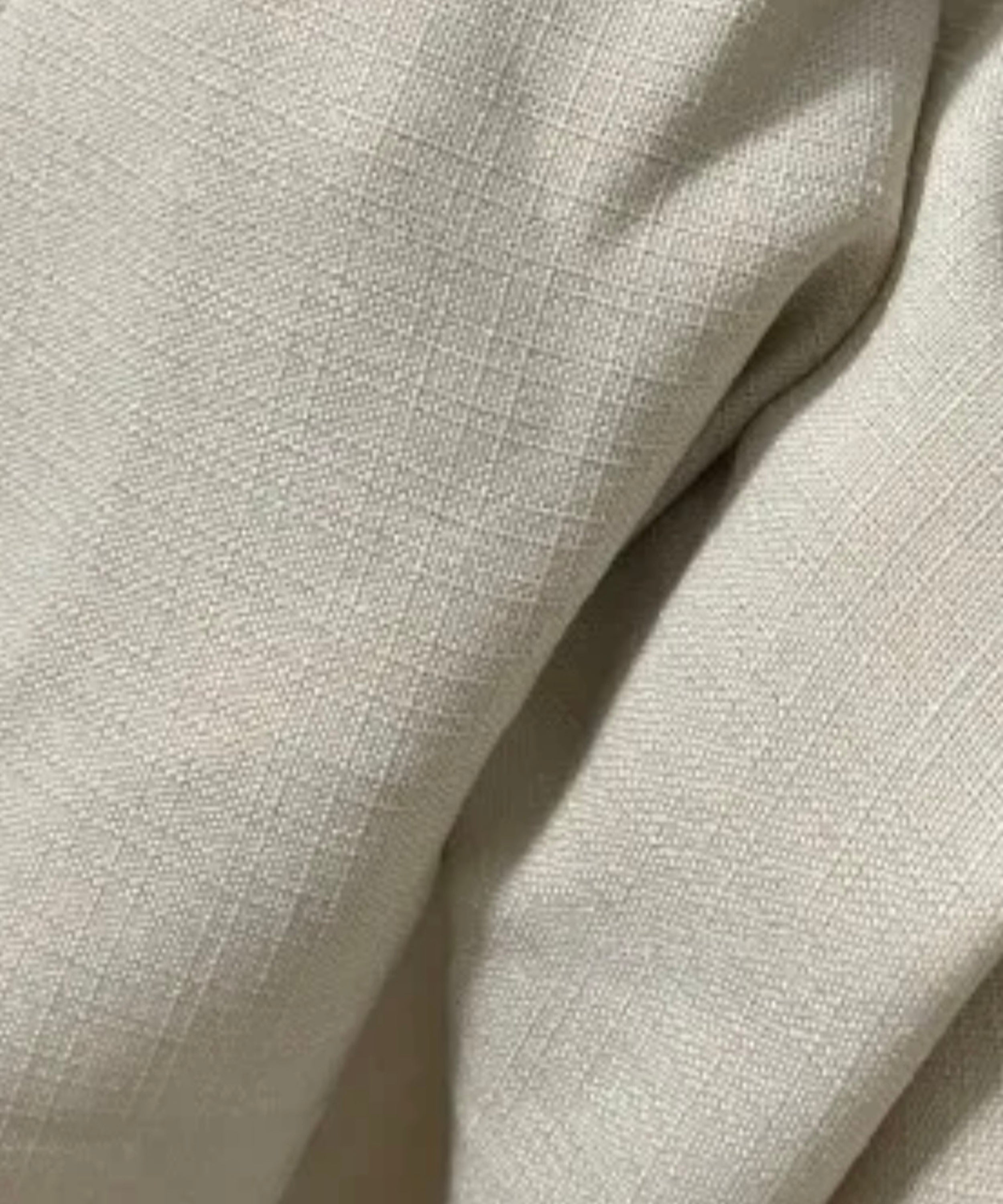 Close-up of beige fabric with a subtle texture