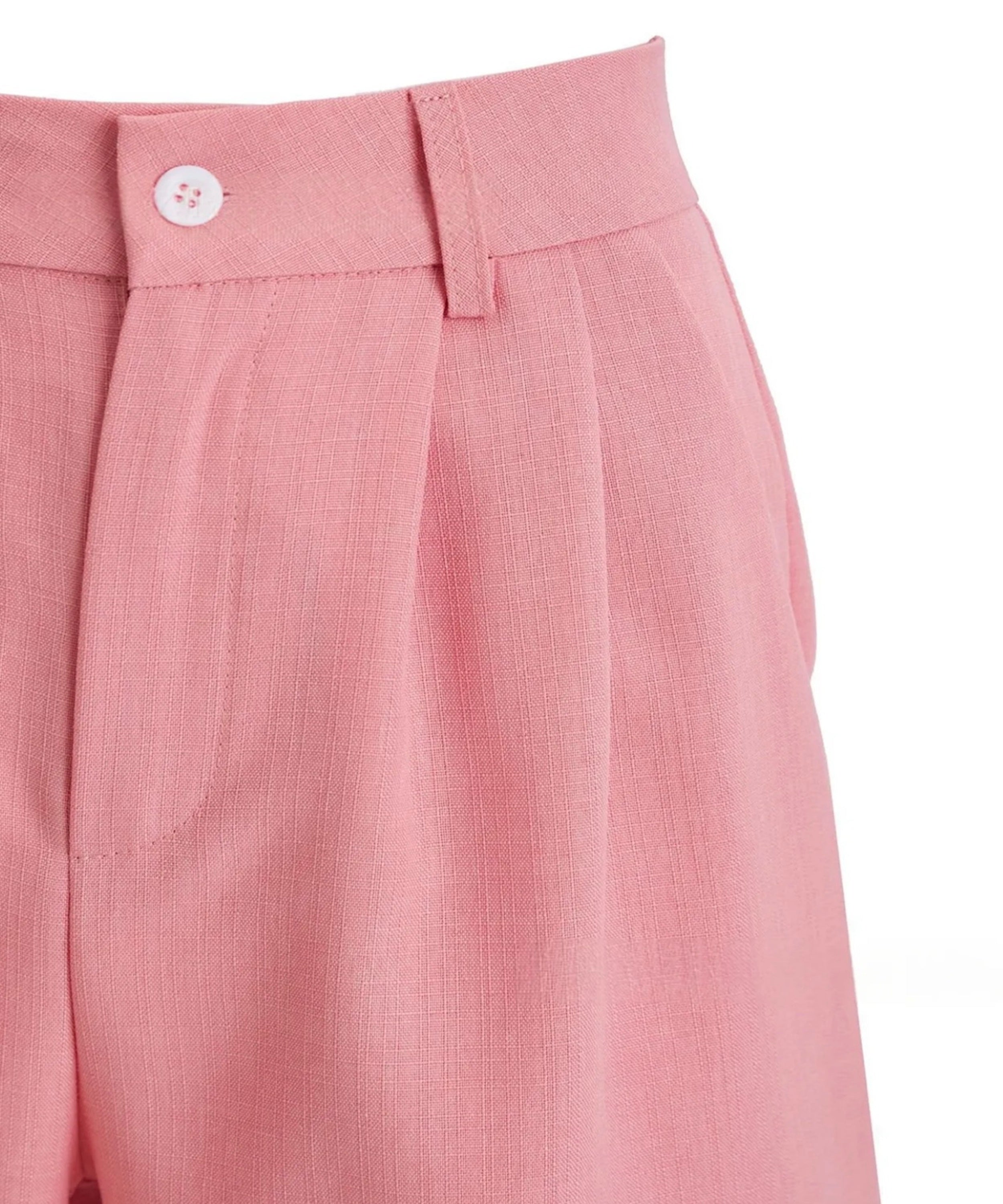 Close-up of pink pleated pants with a button on a white background
