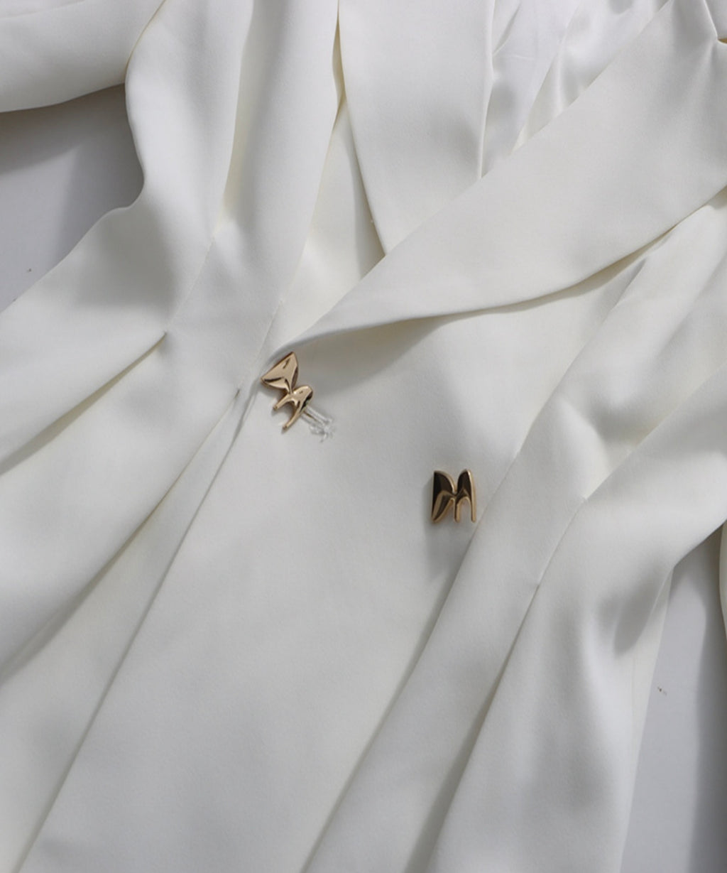 Butterfly-shaped earrings on a white fabric background