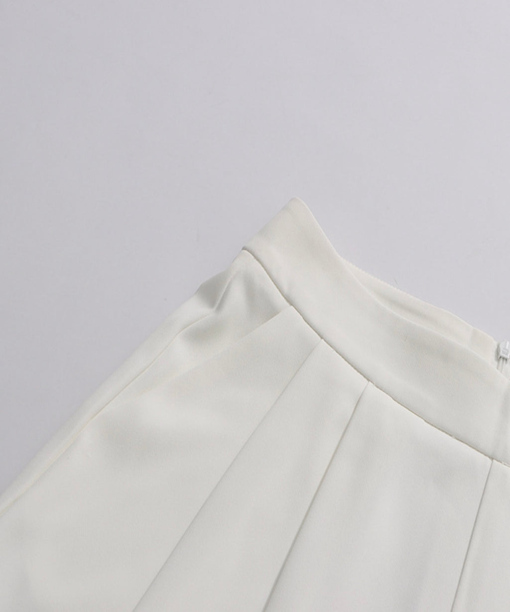 Close-up of a white skirt on a light gray background