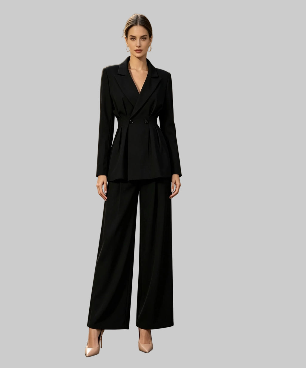 Woman in a black suit standing on a white background