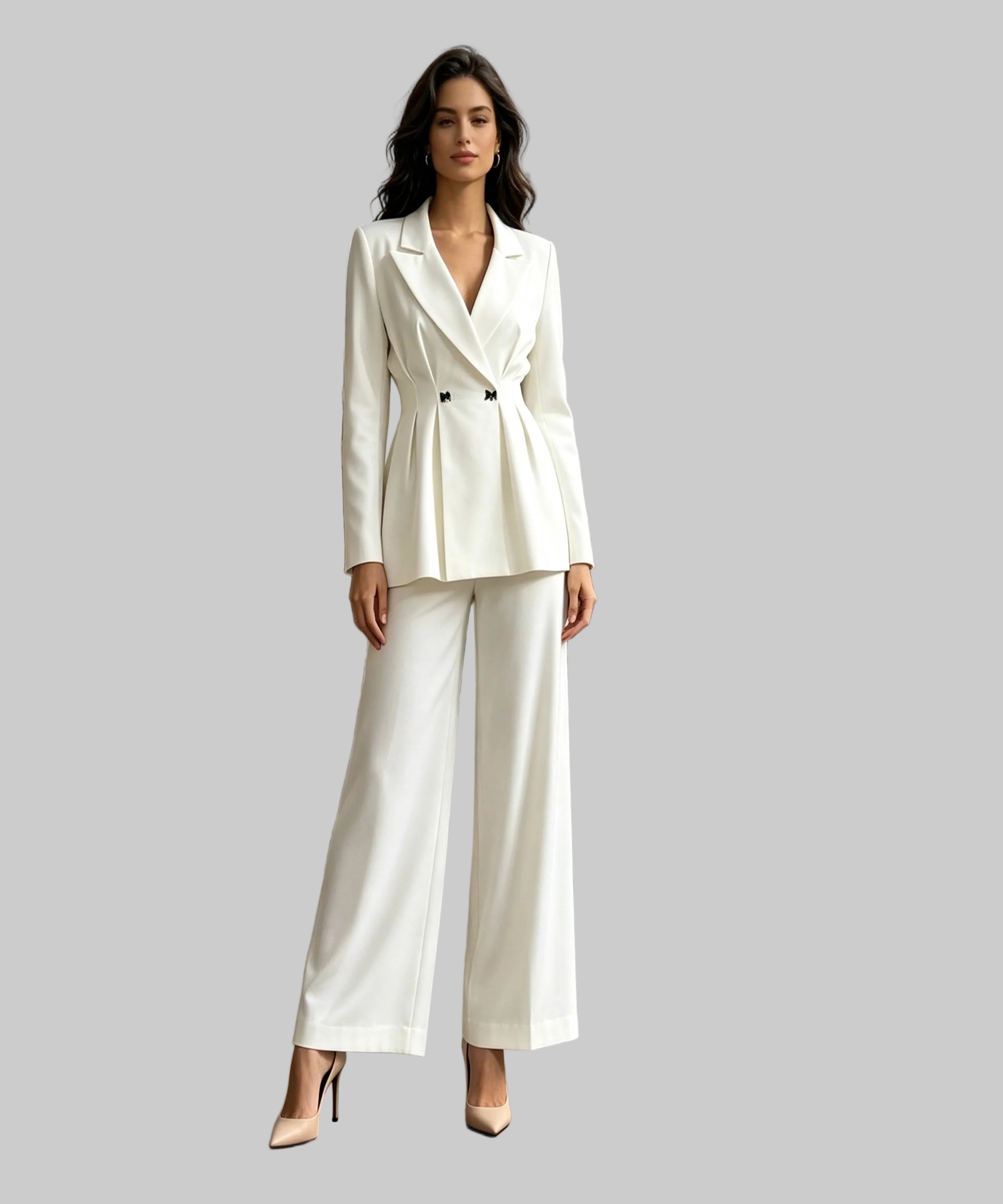 Woman in a white suit standing on a white background.