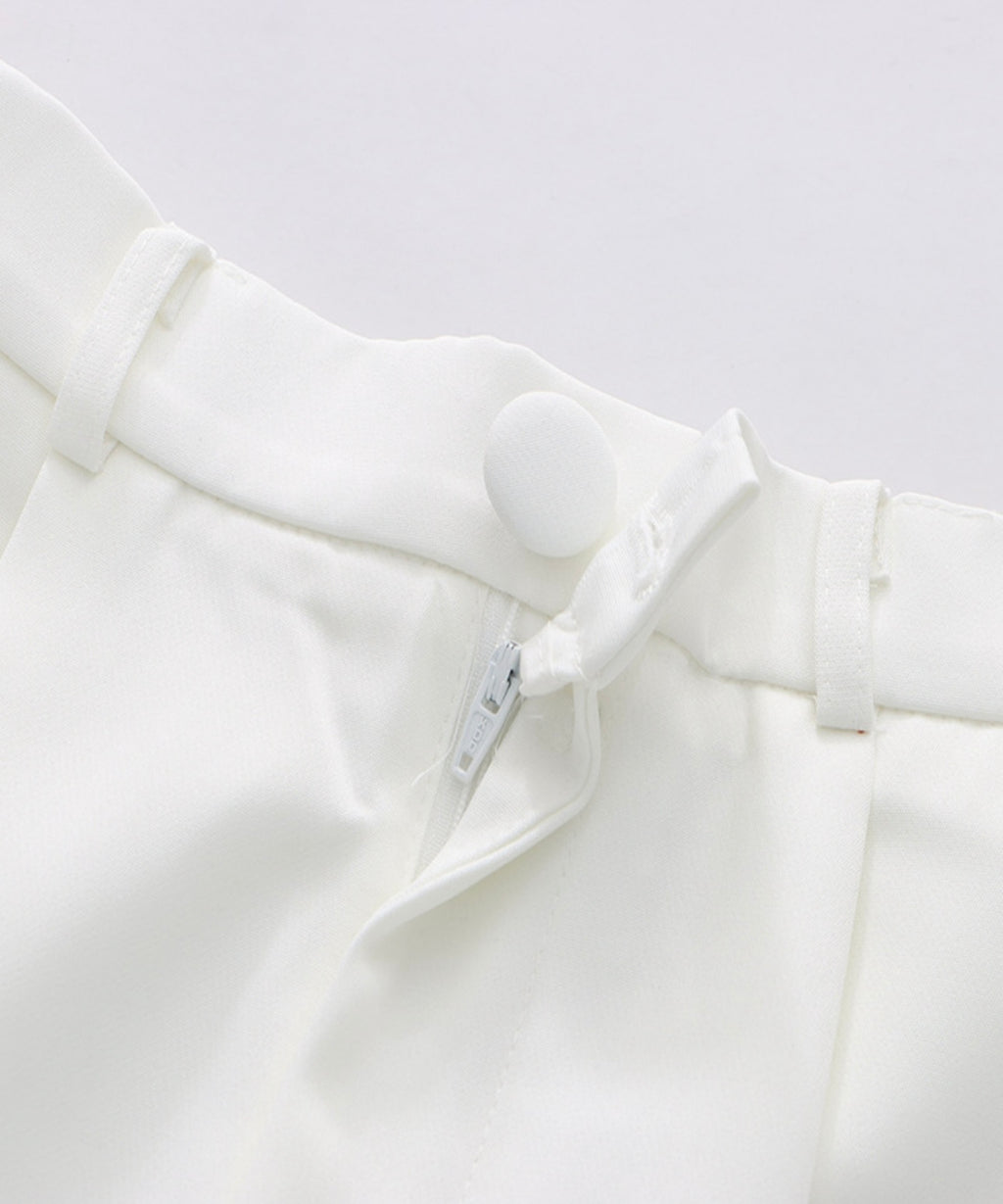 Close-up of a white shirt with a collar and label on a light gray background