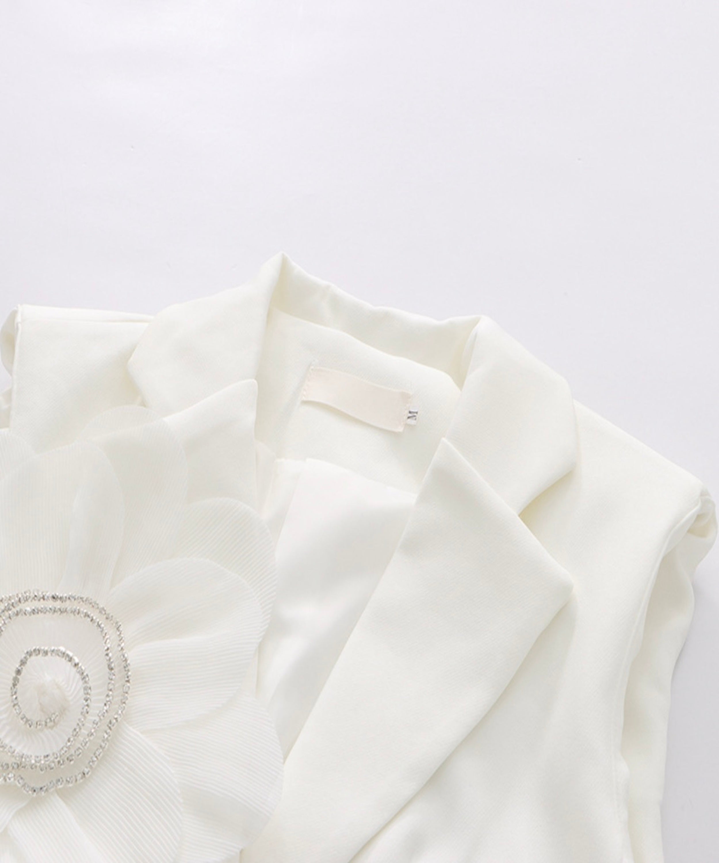 White fabric with a decorative element on a light gray background