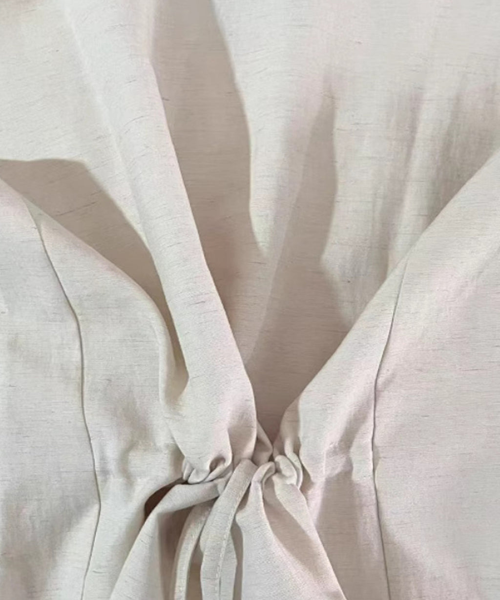 Close-up of beige fabric with folds and shadows