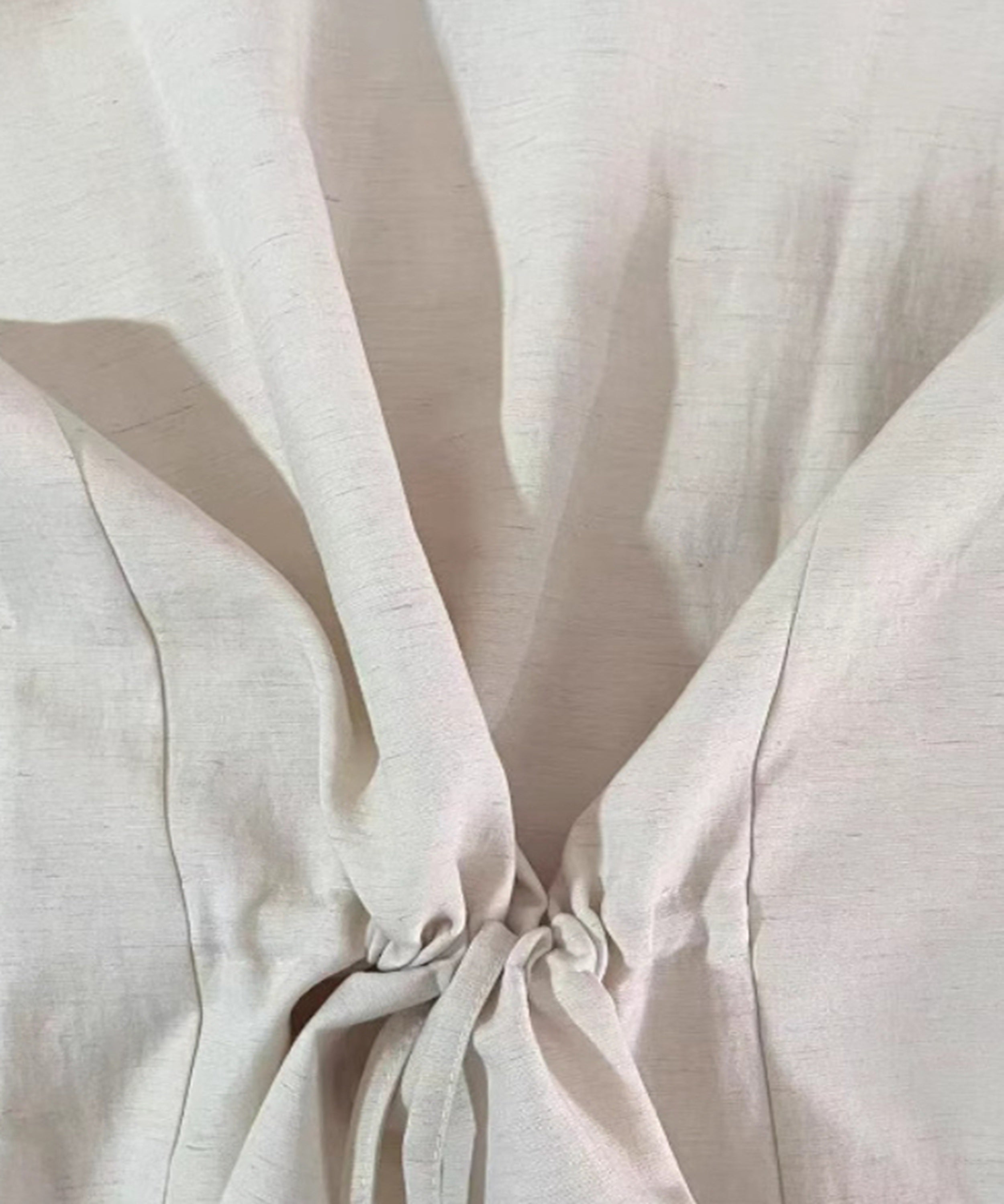 Close-up of beige fabric with folds and shadows