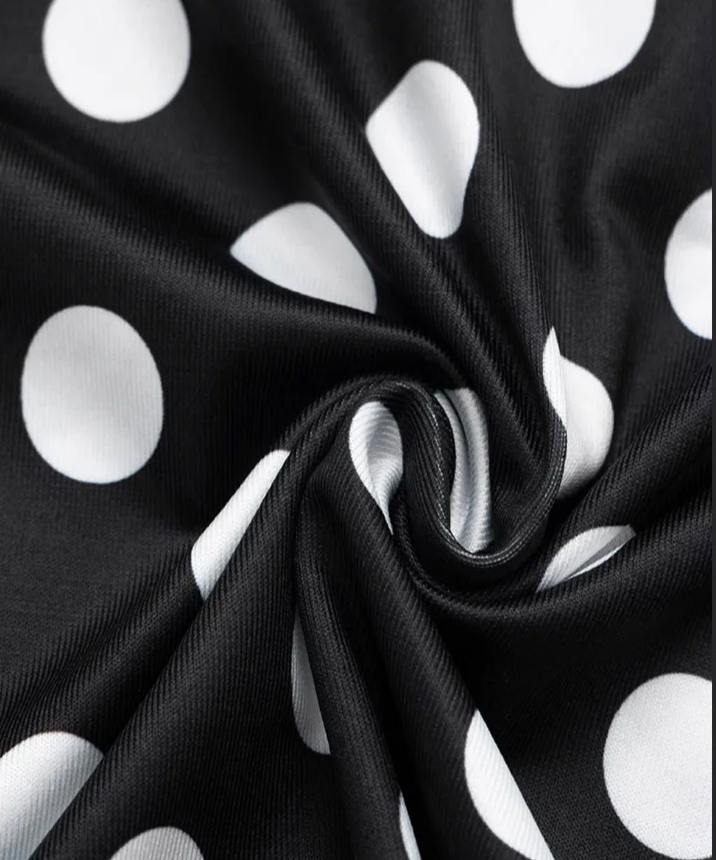 Black fabric with white polka dots