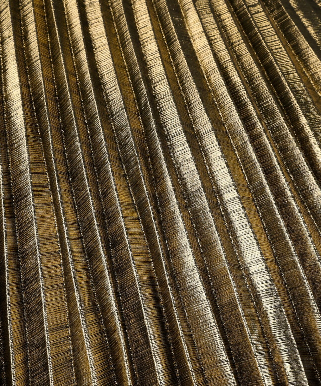 A close-up of a pleated fabric or wallpaper texture with vertical folds in a metallic gold and bronze colorway.