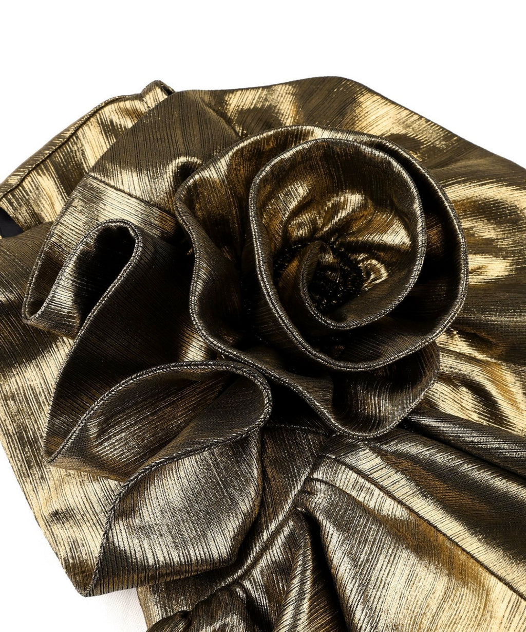 A close-up of a metallic gold and bronze textured fabric accessory, featuring a large rosette flower applique on a white background.