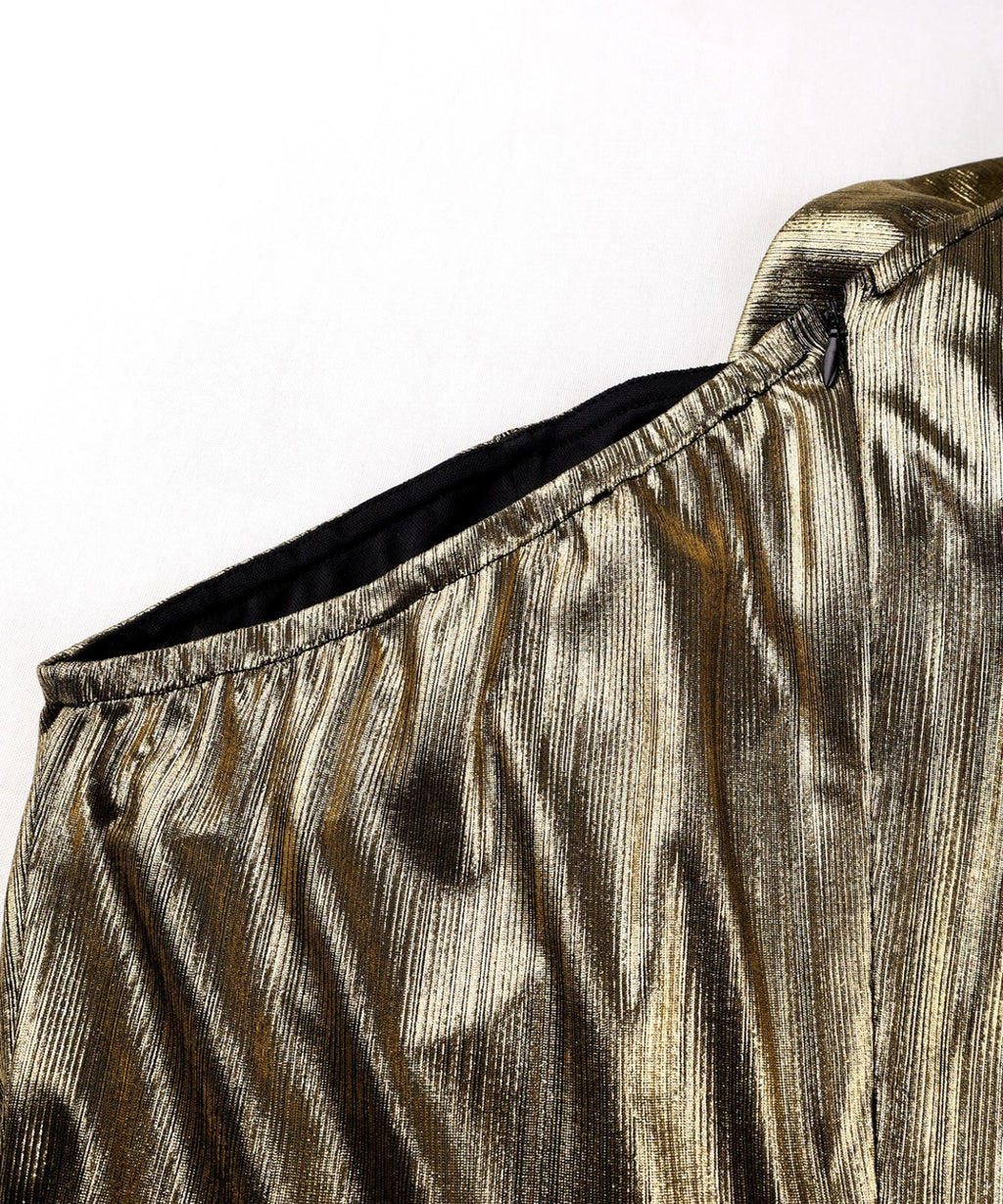 Close-up of a metallic gold and black outfit with a white background