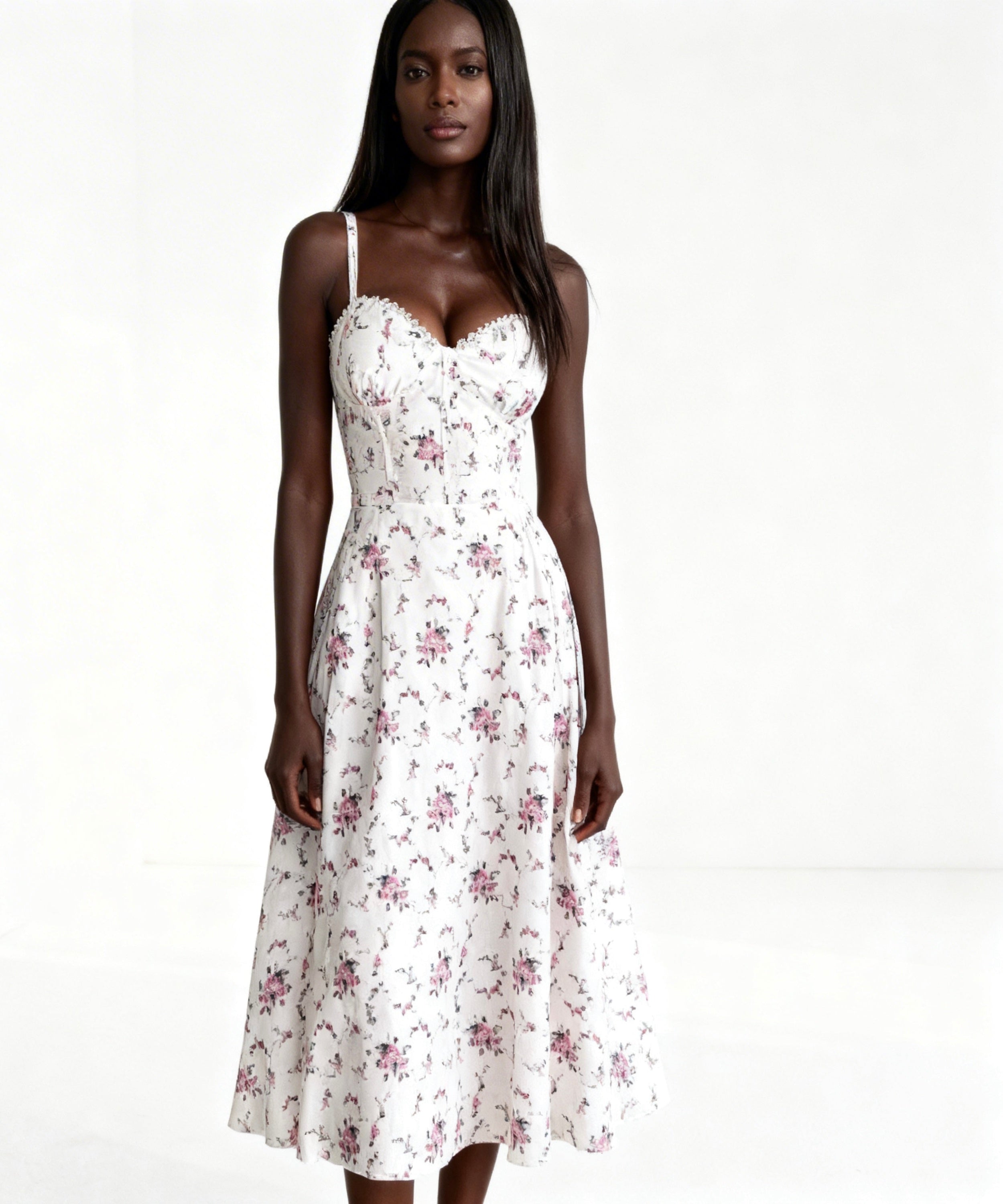 Woman wearing a white floral dress on a white background
