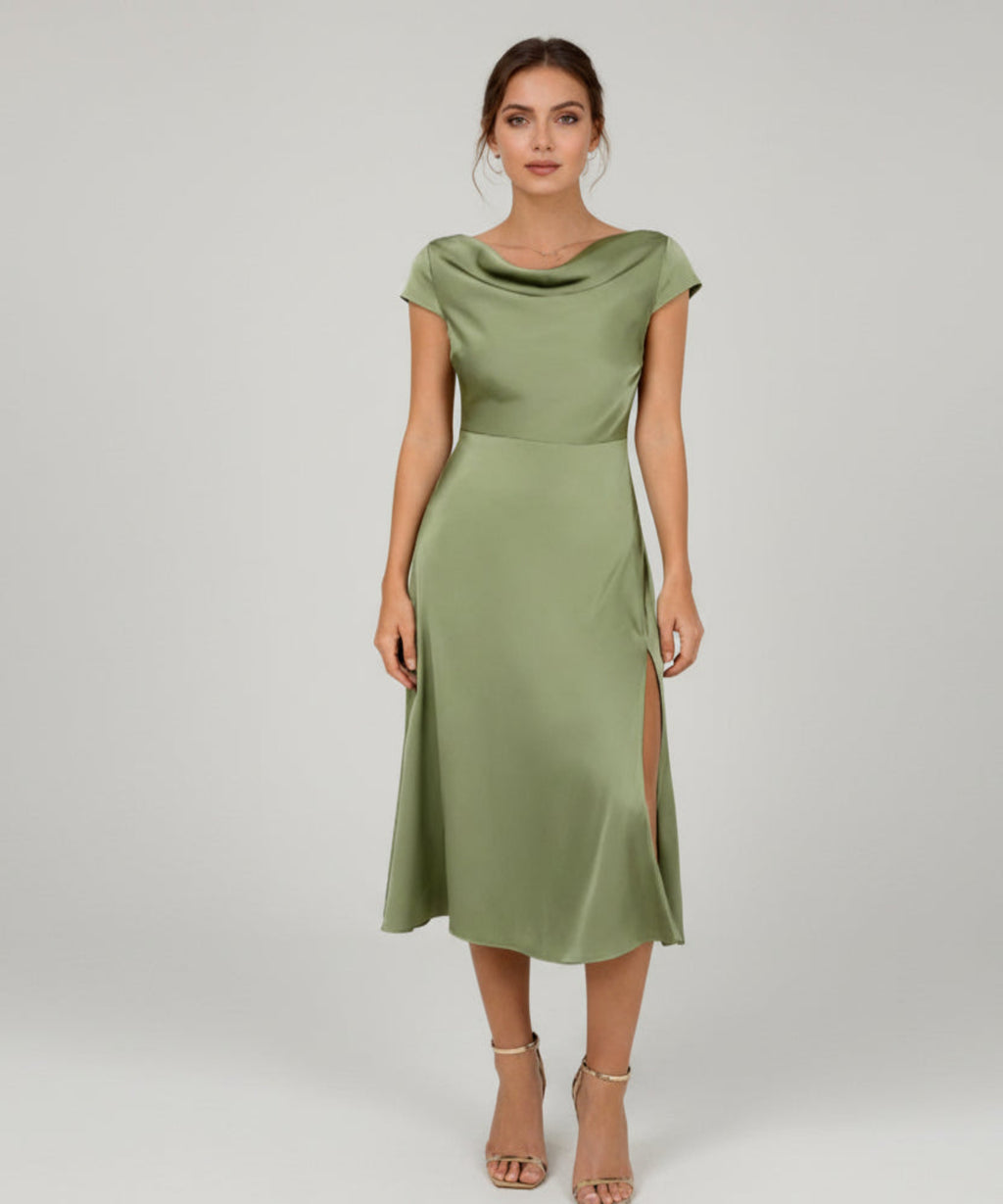 Woman wearing a green dress on a white background