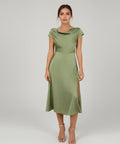 Woman wearing a green dress on a white background