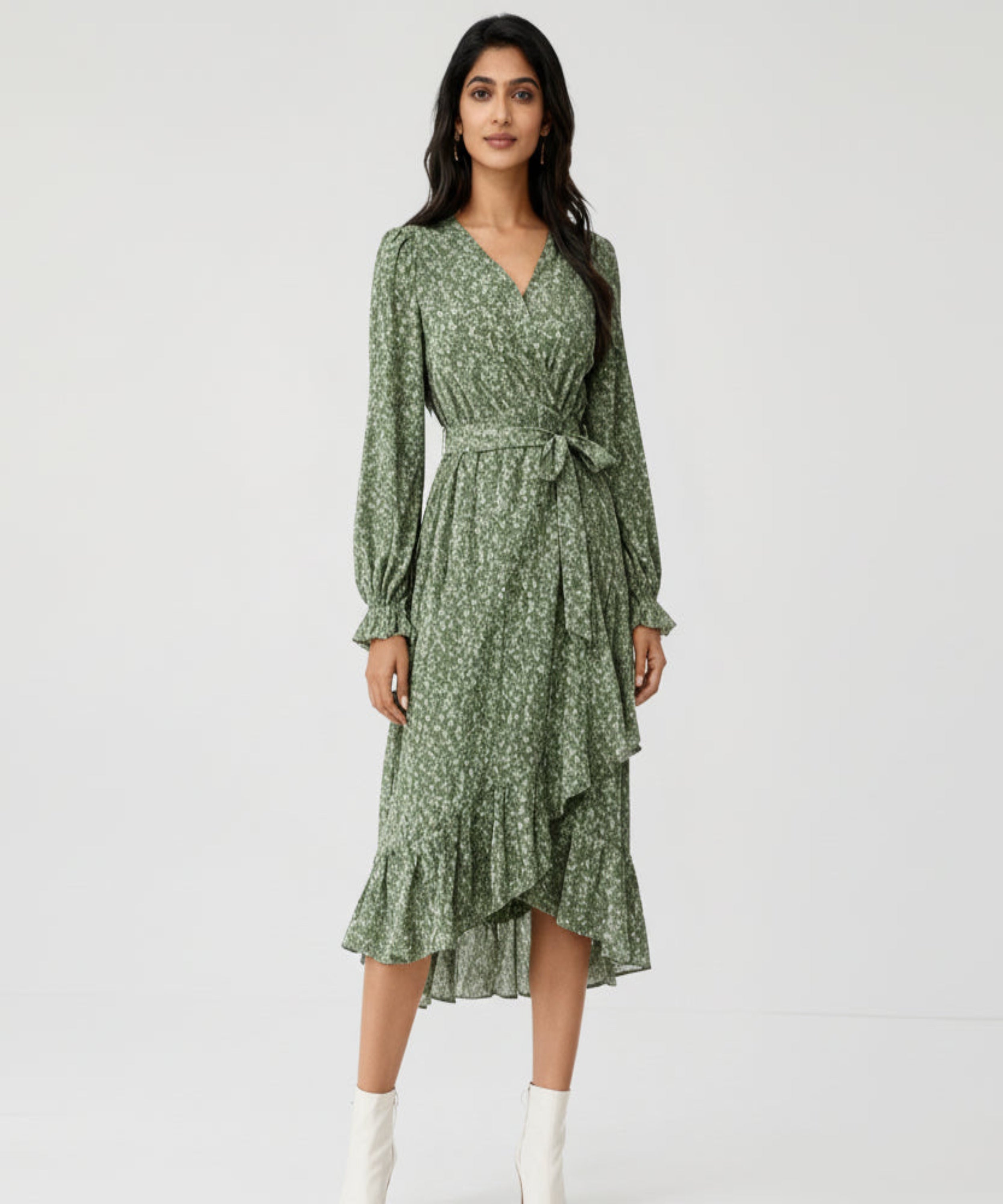 Woman wearing a green floral dress on a white background