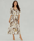 Woman wearing a patterned dress on a white background