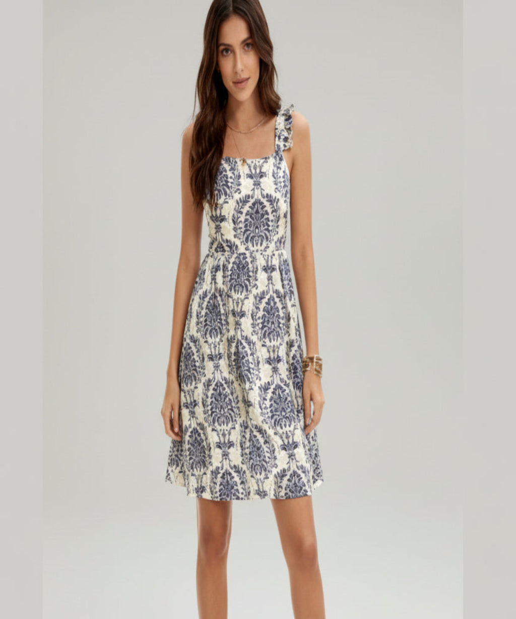 Woman wearing a patterned dress on a white background